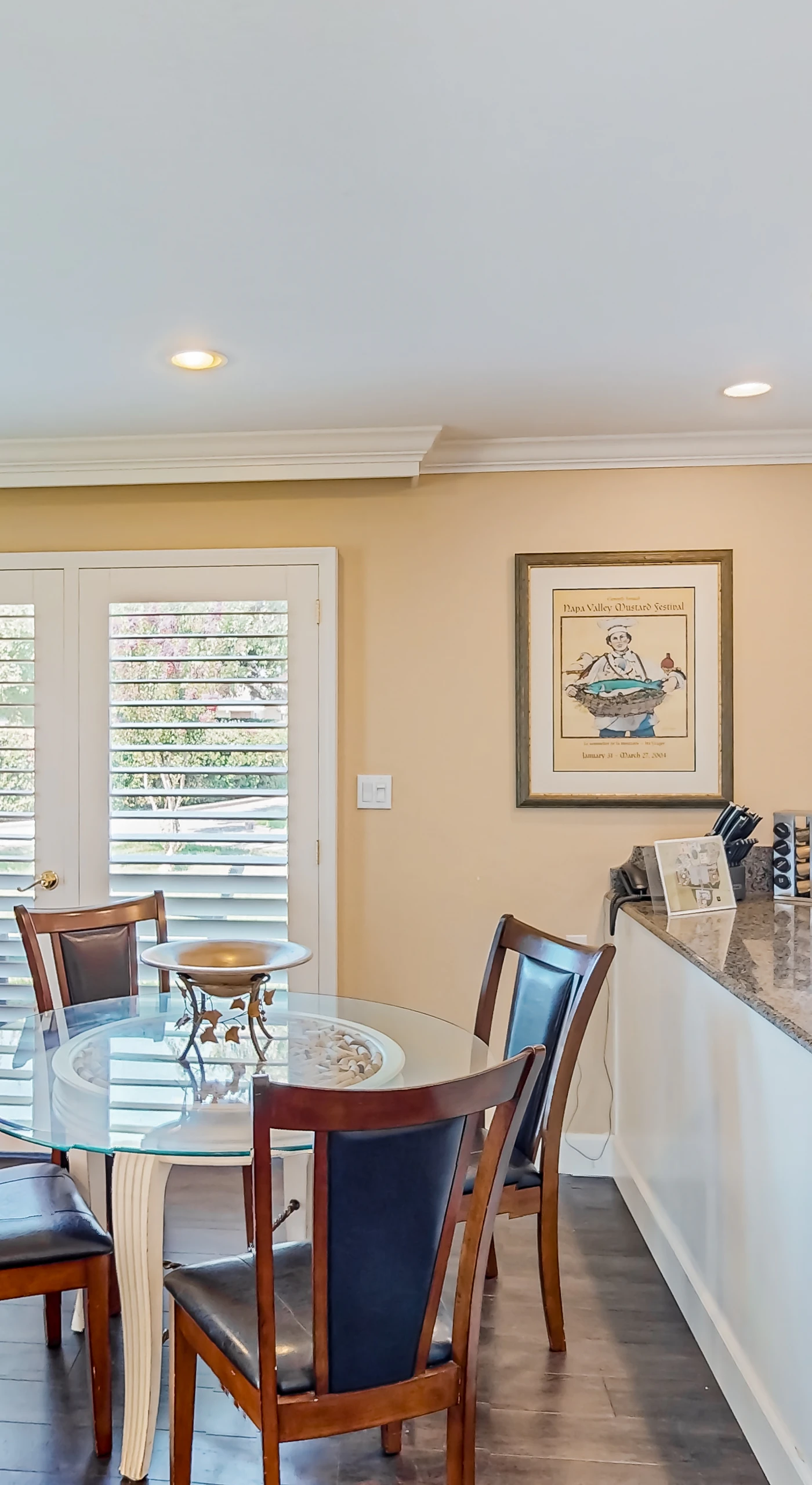 Enjoy farm-to-table Napa cuisine at your glass dining table with views through plantation shutters and a fully equipped kitchen steps away