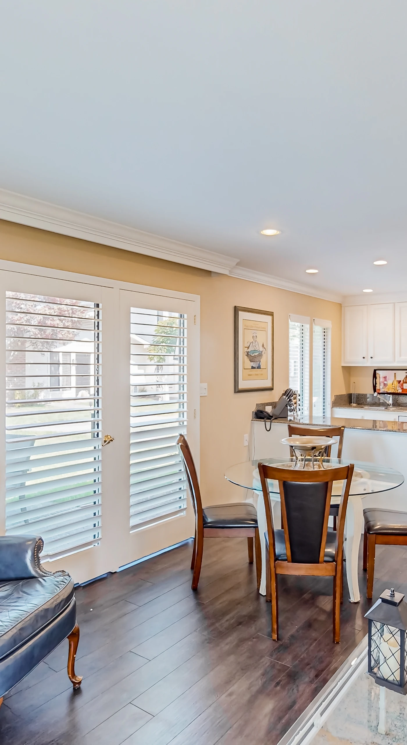 Gather around the dining table bathed in natural light through plantation shutters — an inviting spot to plan your next Napa winery visit over morning coffee.