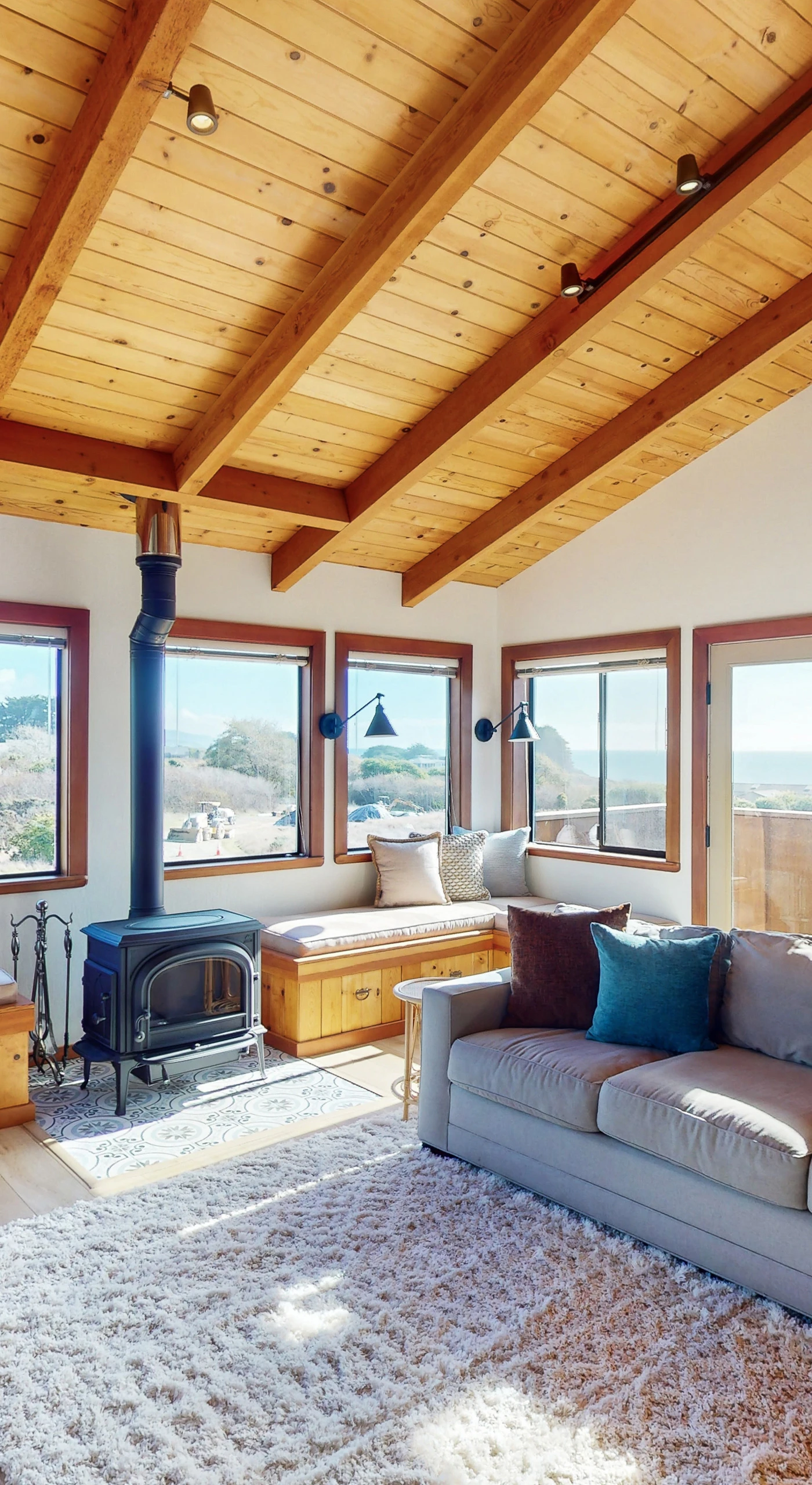 With panoramic windows framing stunning vistas, this inviting living room is designed for both relaxation and entertaining.