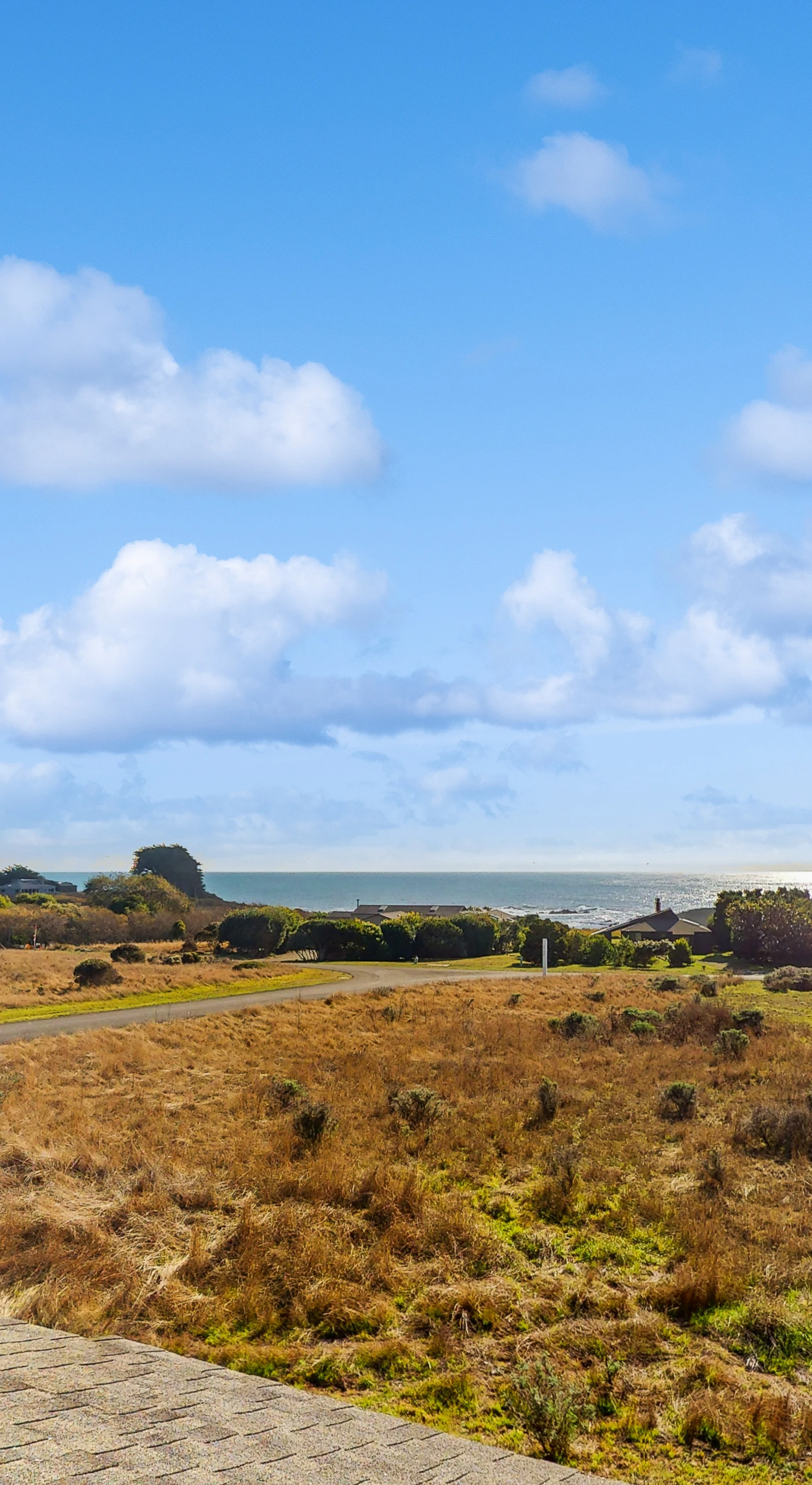 Gaze out over the stunning coastal landscape from Bahari House, where rolling hills meet the sparkling ocean, inviting you to explore the beauty of Sea Ranch.