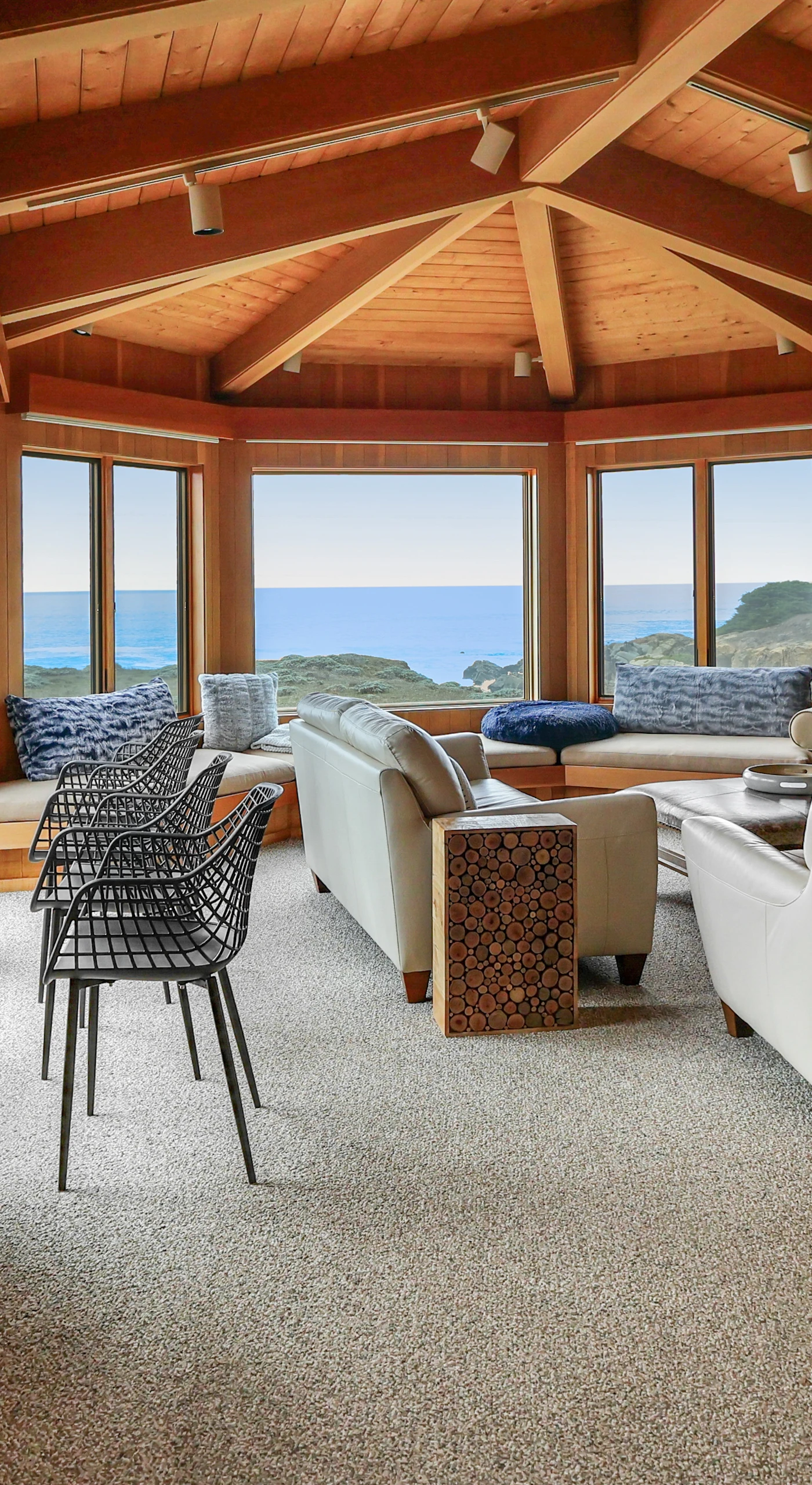 Natural light floods this cozy living room, creating the perfect atmosphere to unwind while gazing at the ocean beyond.