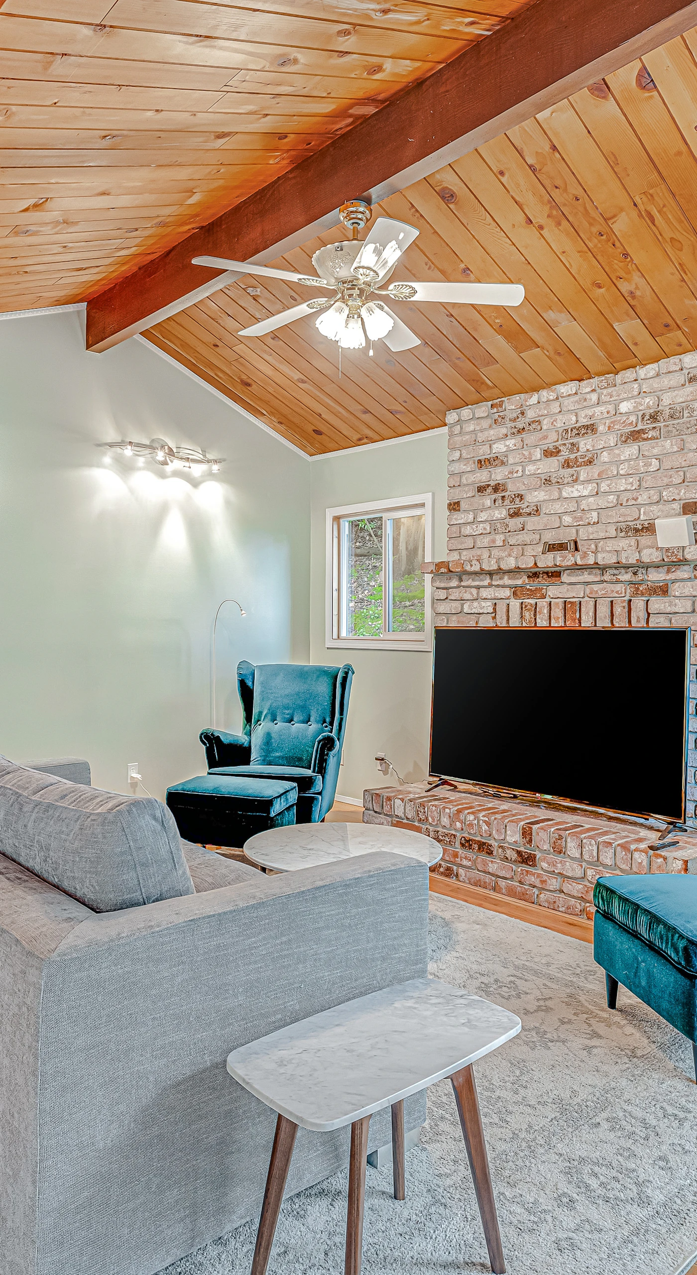 Generous open-concept living flows effortlessly under soaring tongue-and-groove ceilings — your home base for exploring Forestville's tasting rooms and river beaches.