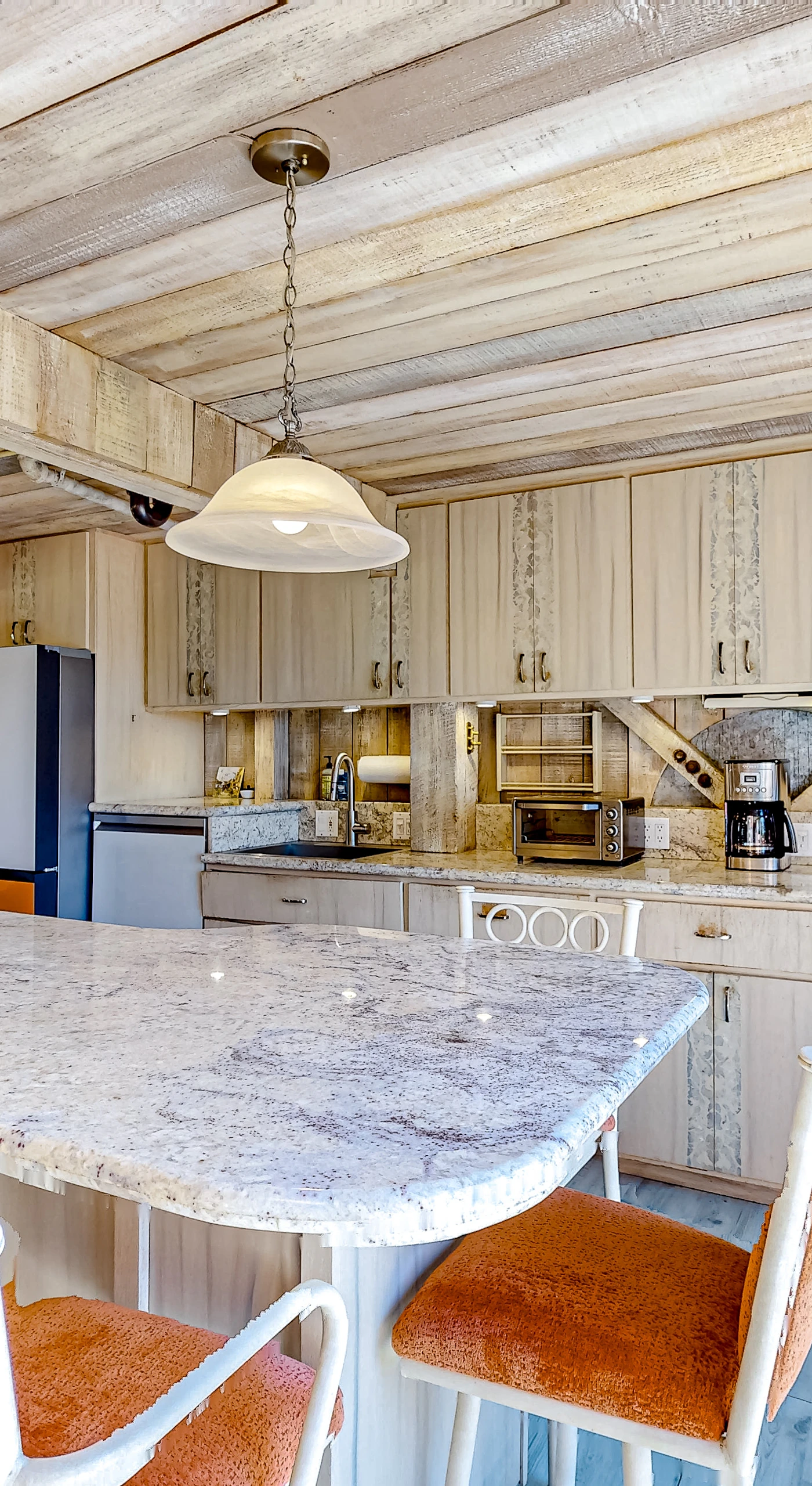 Cook up a culinary masterpiece in this spacious kitchen, featuring modern appliances and ample counter space for your meal preparations.