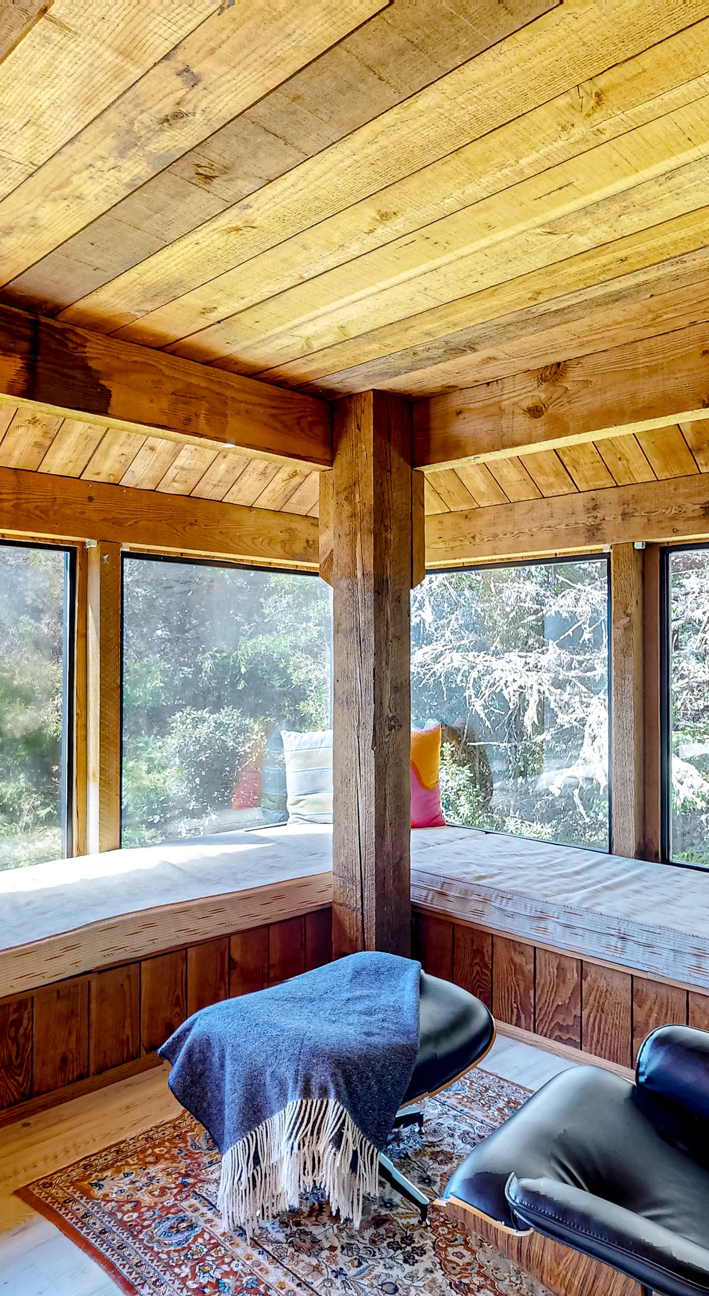 Imagine curling up with a good book on this sunny window seat, surrounded by the serene beauty of nature just outside.