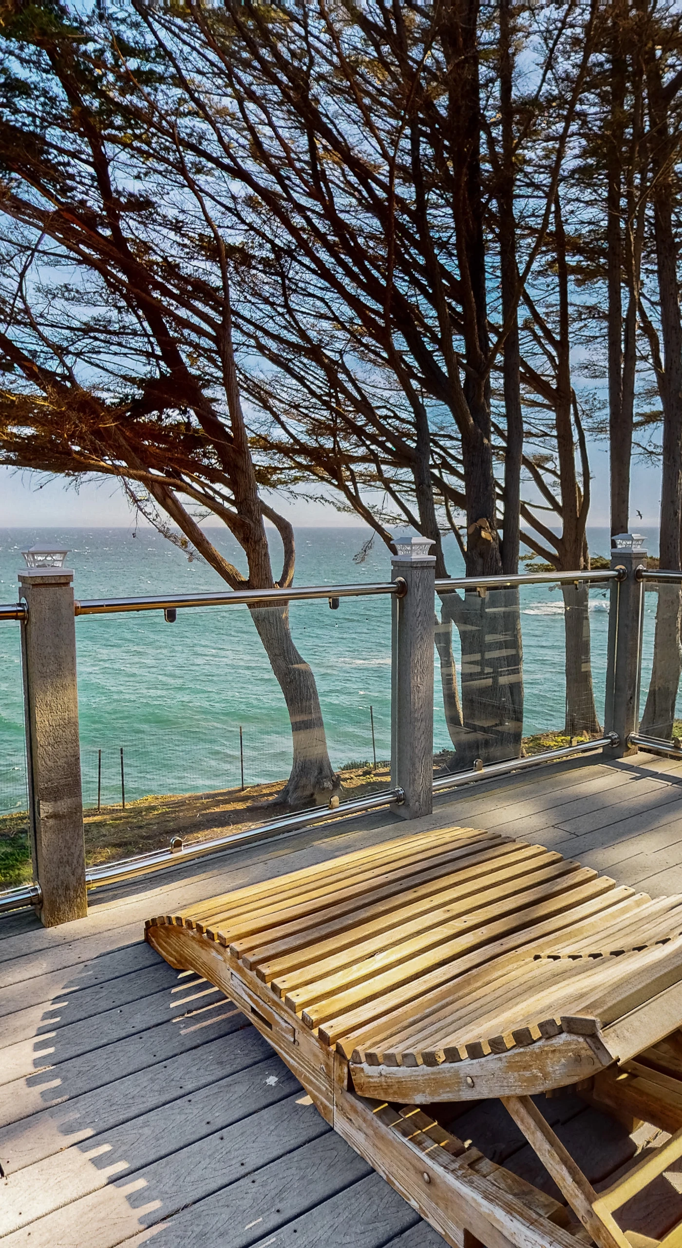 Relax on this sun-drenched deck, where the gentle sway of the trees and the sound of waves create the perfect setting for lazy afternoons.