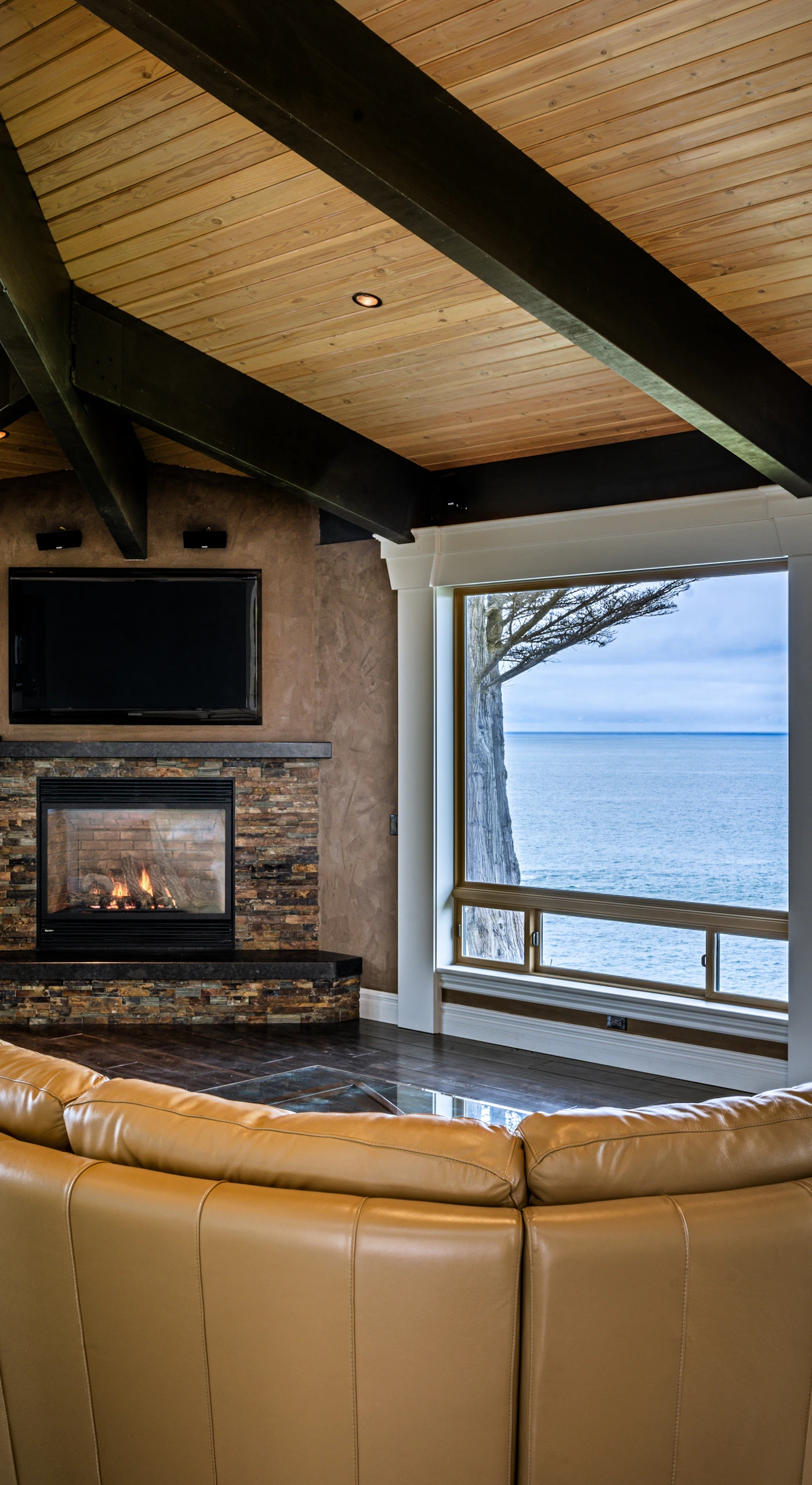 Gather around the cozy gas fireplace in the inviting living room, where comfort meets stunning ocean vistas.