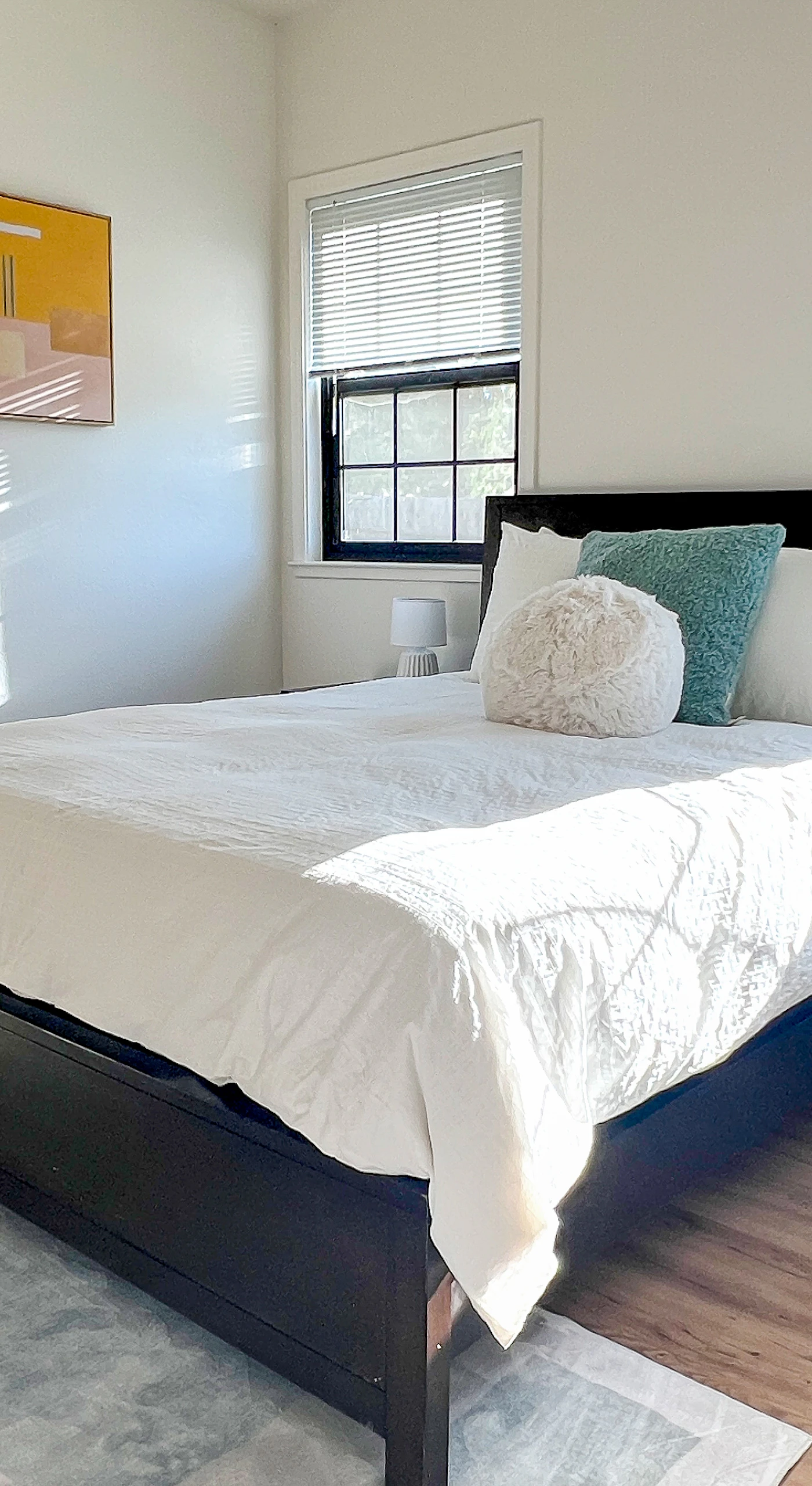 Bright and airy, your third bedroom features a queen bed with crisp white linens and accent pillows — natural light streams through double windows for a refreshing Penngrove morning.