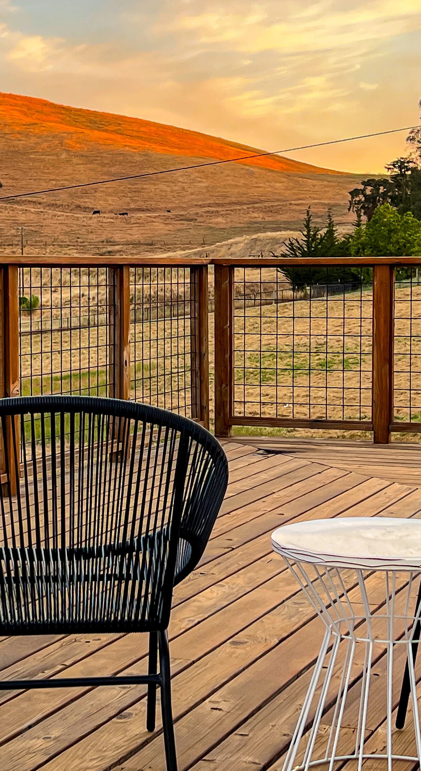 Settle into your private deck at golden hour — two modern chairs framing sweeping Sonoma Valley hill views, the perfect perch for sipping local Pinot after a day of wine tasting.