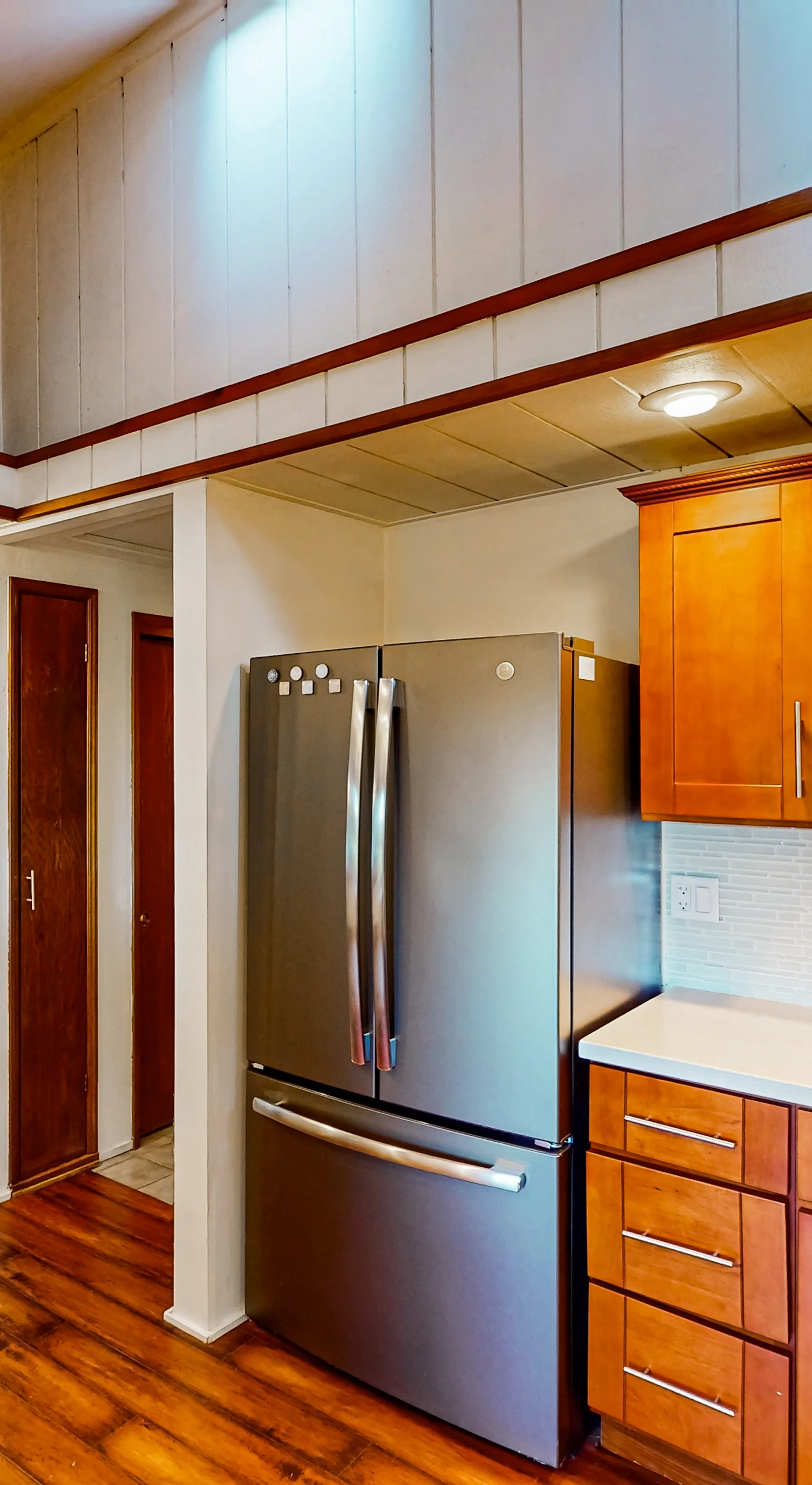 Your fully equipped kitchen features stainless steel appliances, warm cherry cabinets, and gleaming countertops — everything you need to cook with your farmers market finds.