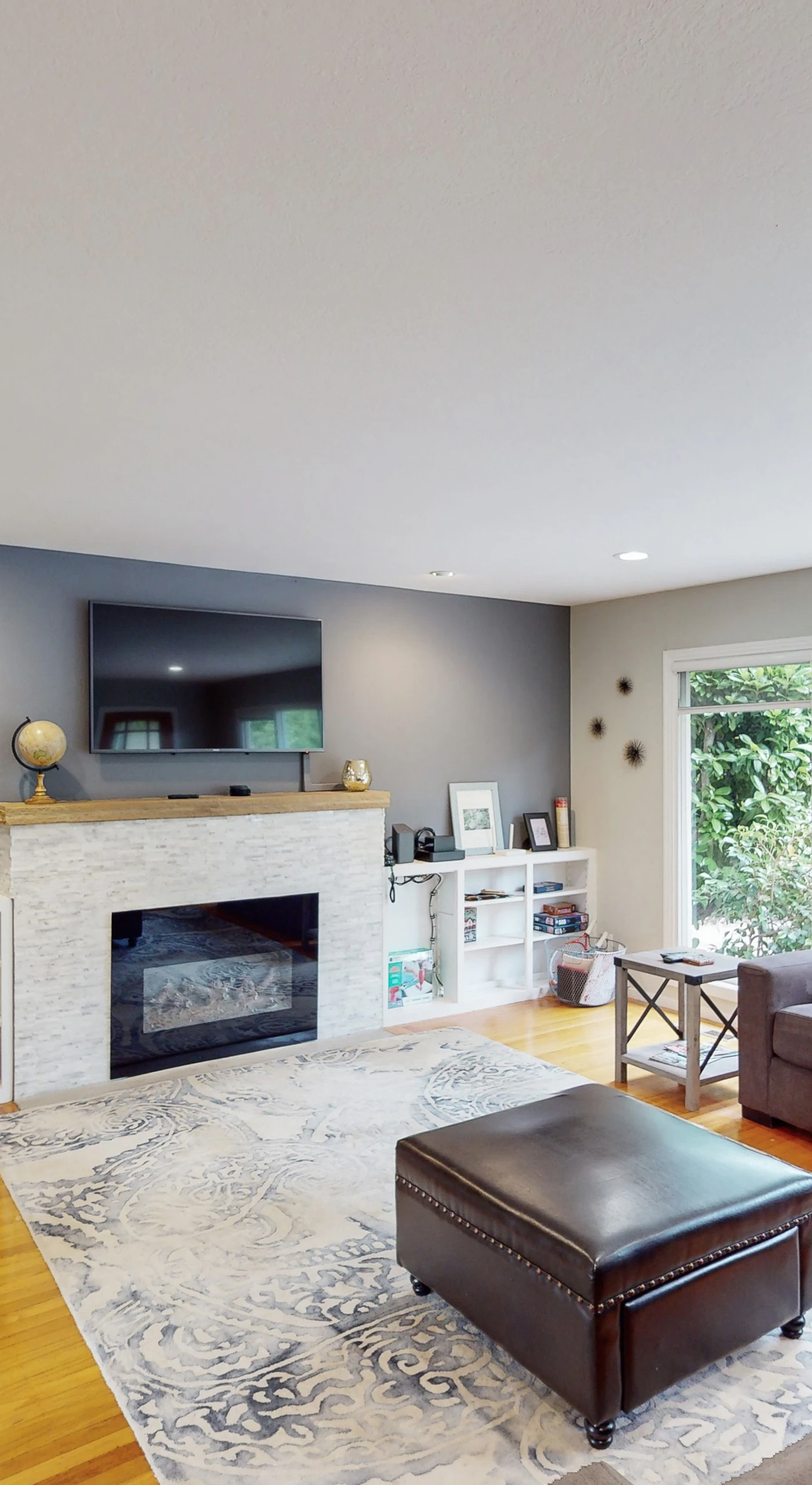 Cozy up by your indoor fireplace with a glass of Sonoma pinot — a wall-mounted TV and stylish accent wall make this the ideal space for quiet evenings in wine country.