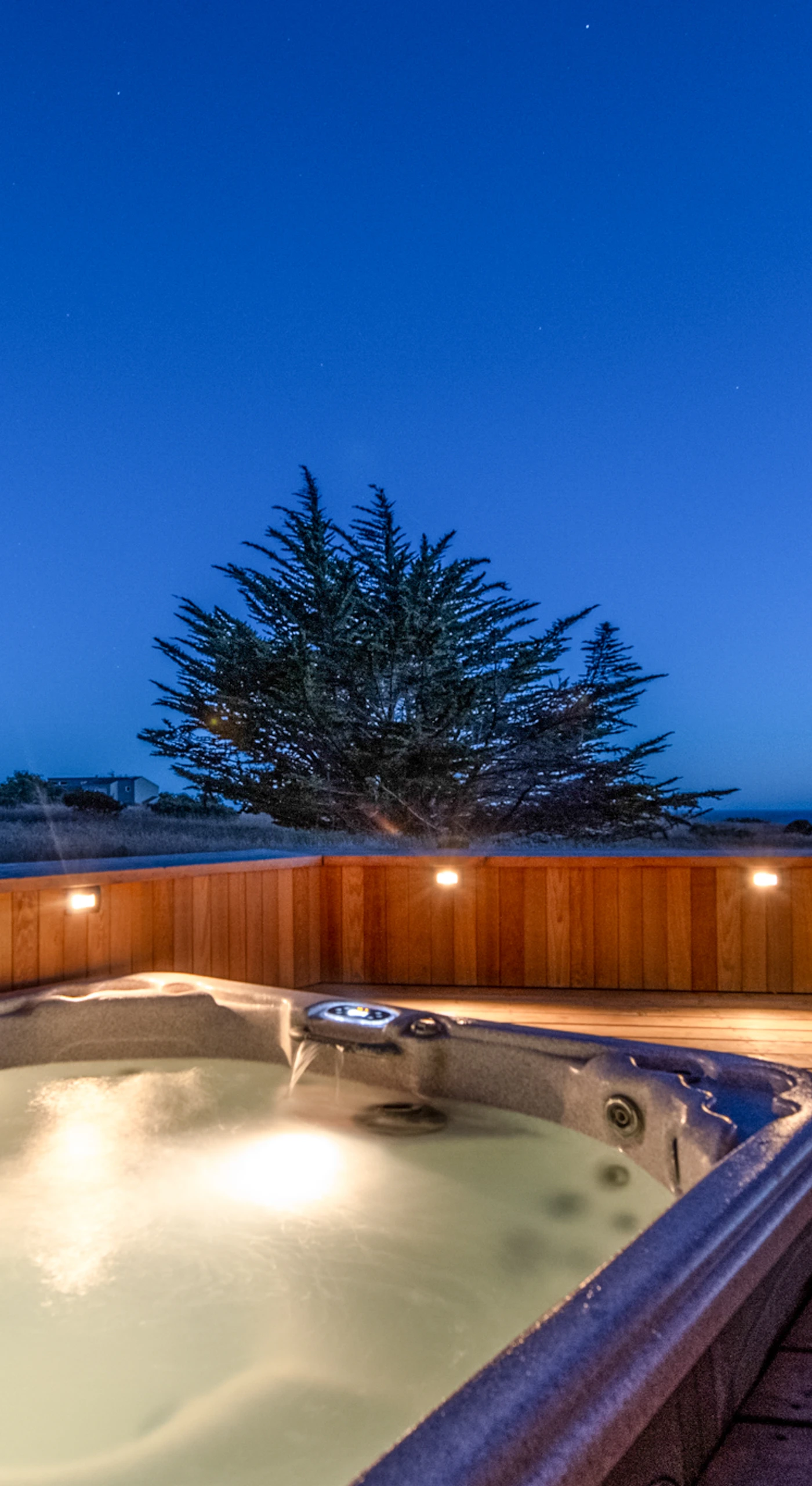 As dusk falls, enjoy the tranquil ambiance of your hot tub retreat, perfect for stargazing and soothing conversations.