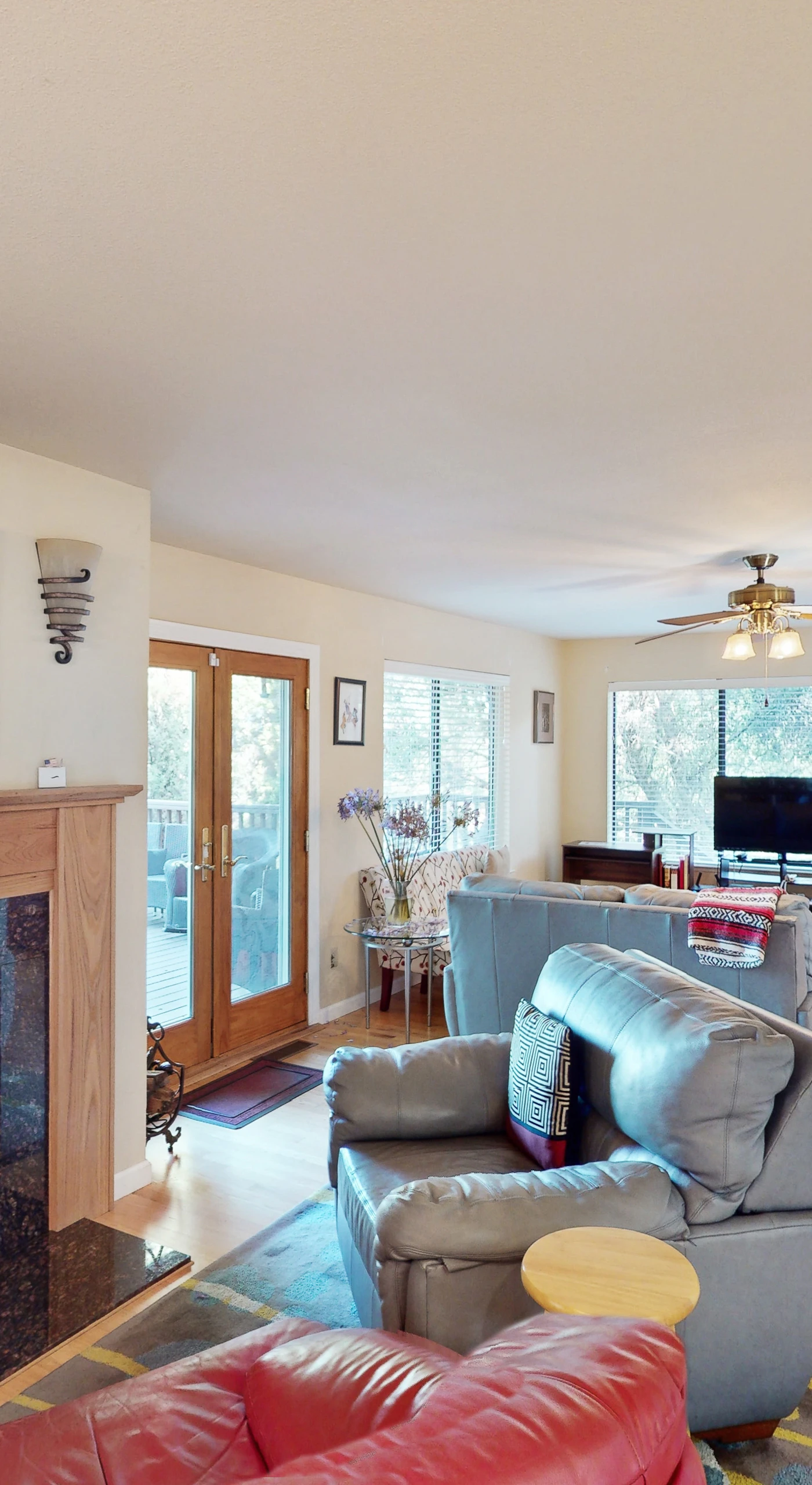 Settle into your sun-drenched living room where a stone fireplace anchors the open floor plan — perfect for unwinding after a day exploring Cloverdale wineries.
