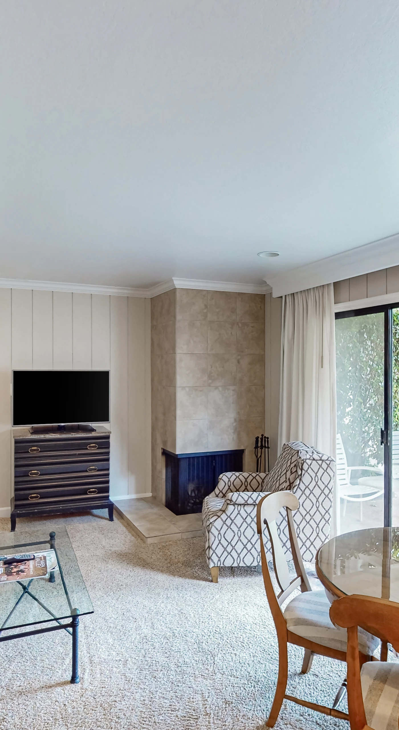 Gather around the fireplace in your spacious Napa condo living room with a flat-screen TV, comfortable seating, and natural light from floor-to-ceiling glass doors