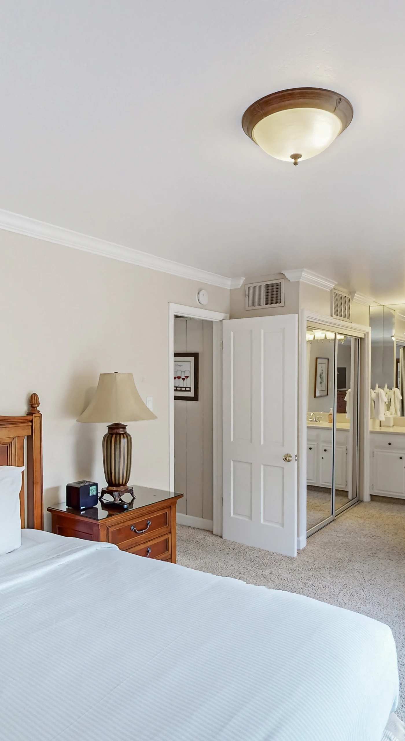Enjoy the suite life with your king bedroom flowing into an ensuite bath — a comfortable armchair by the patio makes for the perfect reading nook