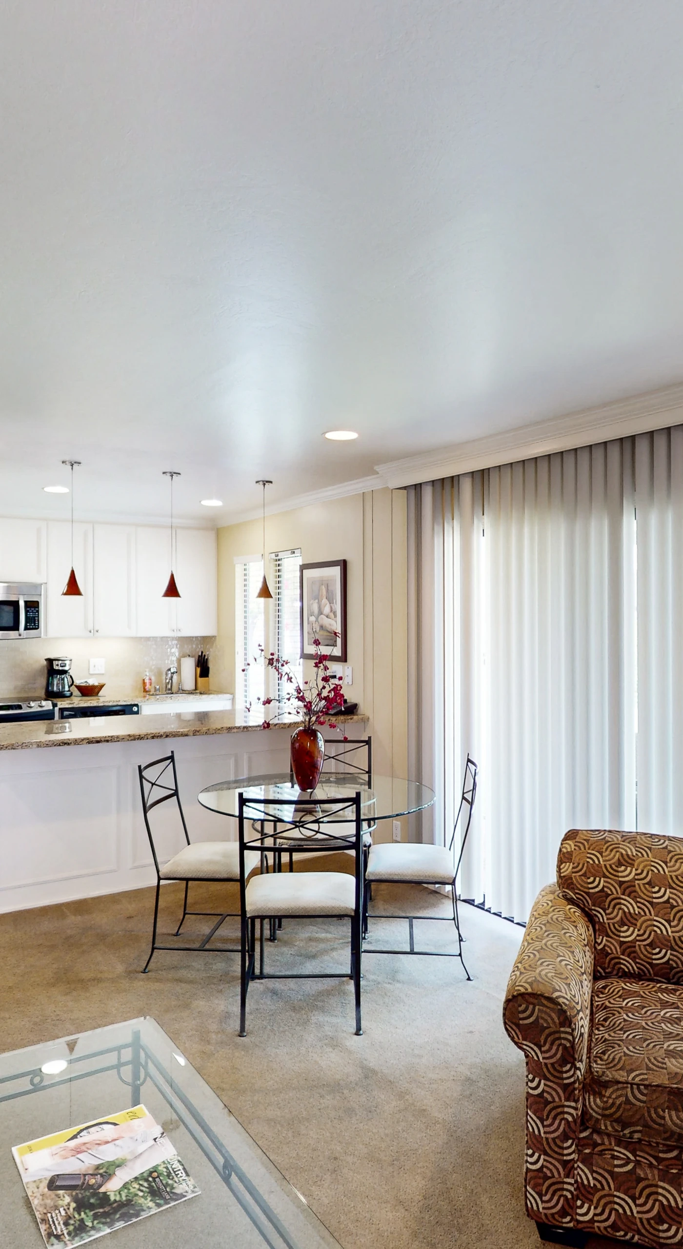 Enjoy your open-concept Napa retreat where the living area flows seamlessly into a modern kitchen and dining space, with natural light streaming through floor-to-ceiling windows.