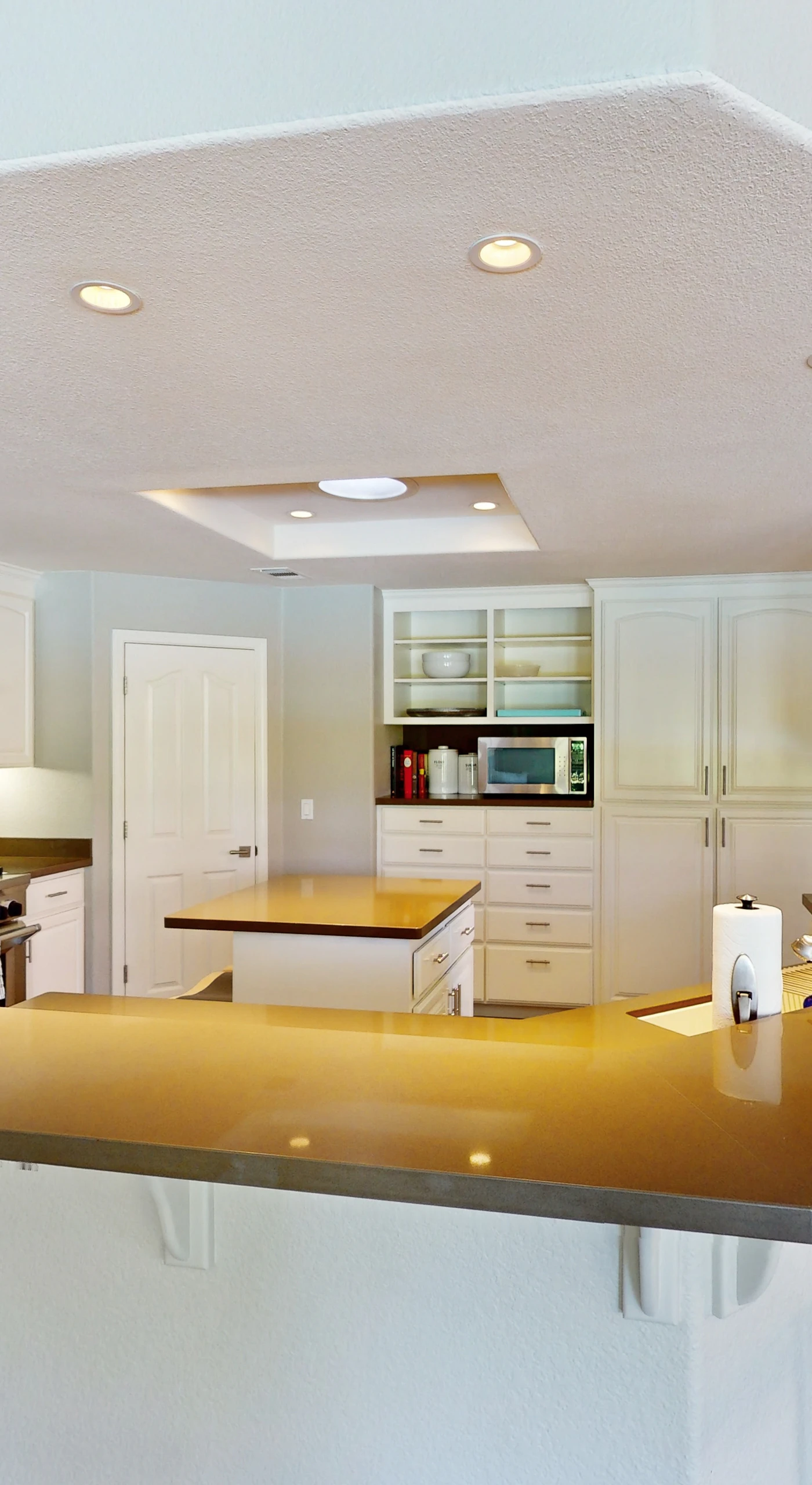 Channel your inner chef in this fully equipped gourmet kitchen with a wraparound island, stainless steel appliances, and room for everyone to pull up a stool.