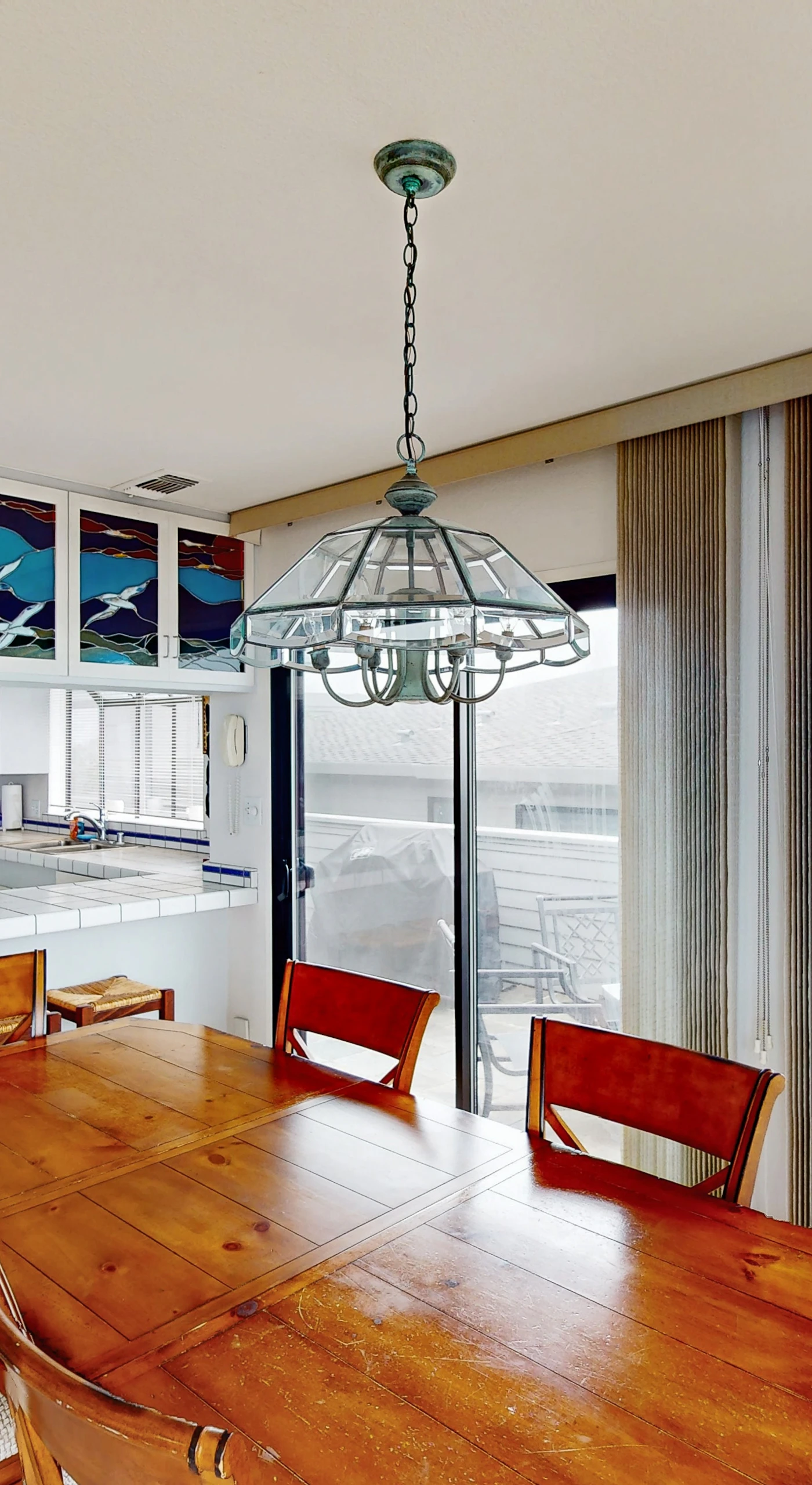 Share fresh Sonoma Coast seafood at your wooden dining table beneath artisan stained-glass panels capturing the colors of the Pacific