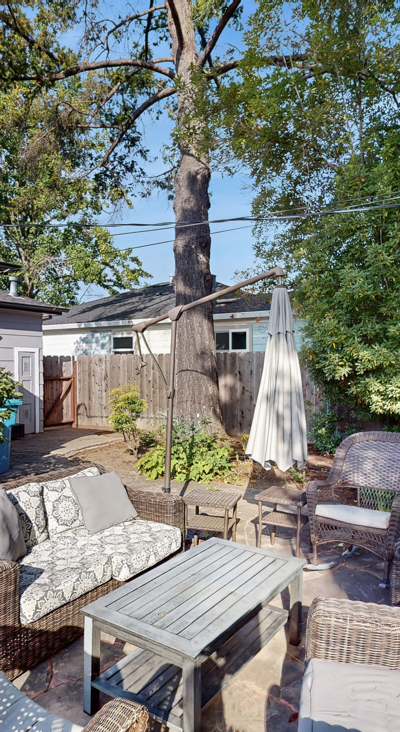 Unwind after a day of Sonoma tastings on your private patio — sink into wicker seating beneath the canopy of a grand shade tree in the enclosed backyard