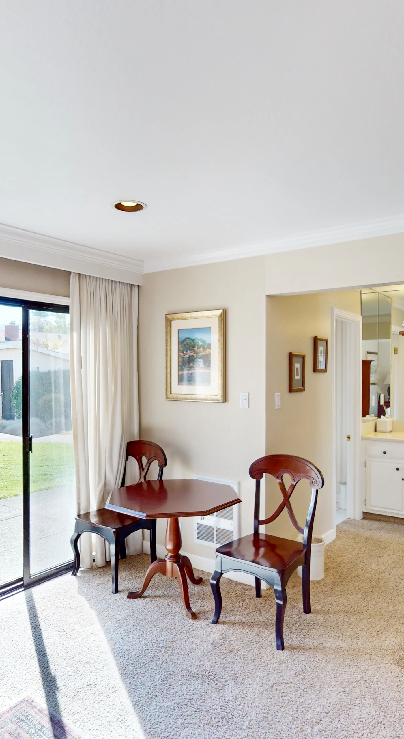 Step from your bedroom directly onto the patio through sliding glass doors — a cherry armoire and bistro table make this Napa hideaway feel like home.