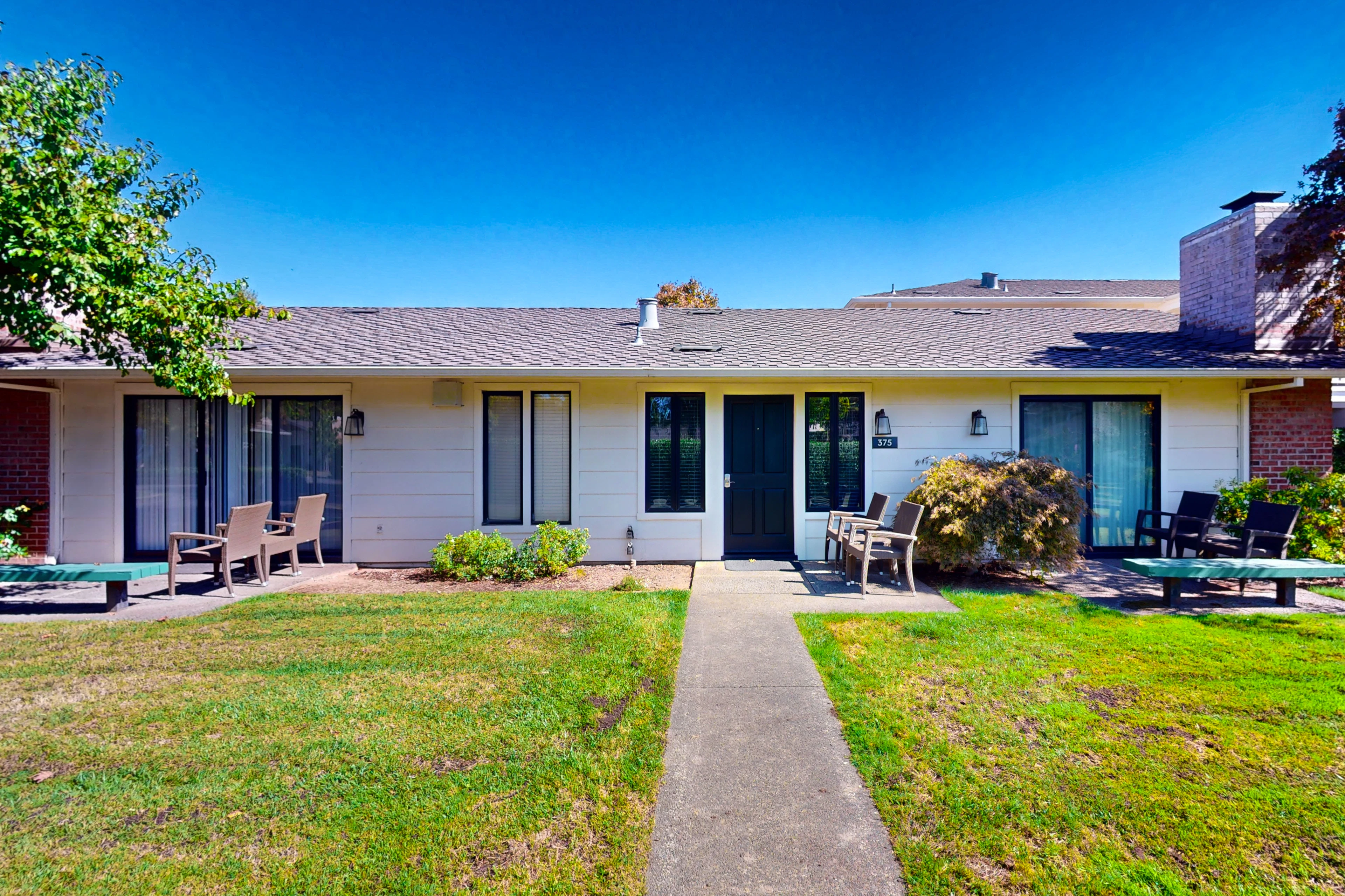 Welcome to your private Napa Valley cottage — step through the front door of Unit 375 to find a single-level retreat with sunny patio seating and manicured resort lawns.