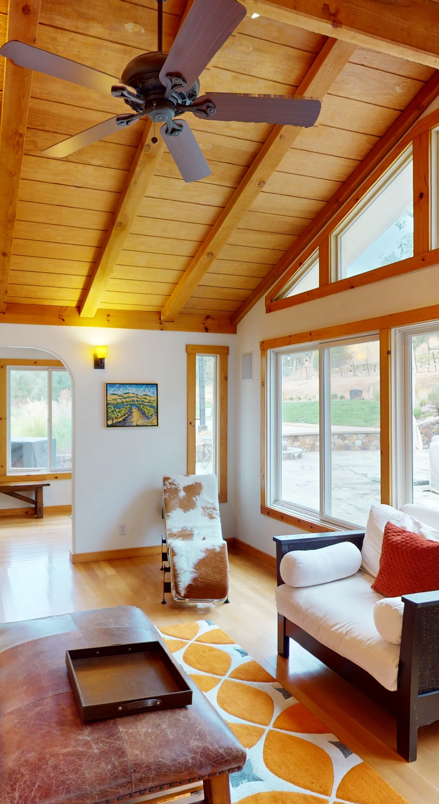 Sunlight pours through floor-to-ceiling windows into your vaulted cedar living room — the perfect spot to unwind after a day exploring Sonoma Valley tasting rooms.