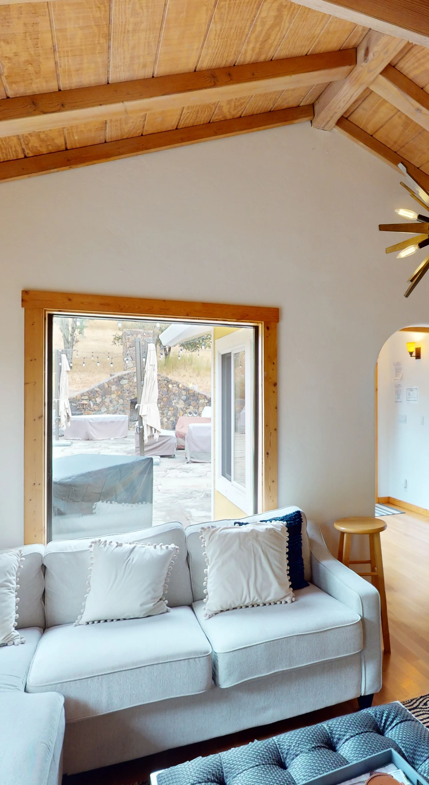 Curl up by the stone fireplace in your cozy family room — a mid-century sputnik chandelier and bold local art add Sonoma creative flair.