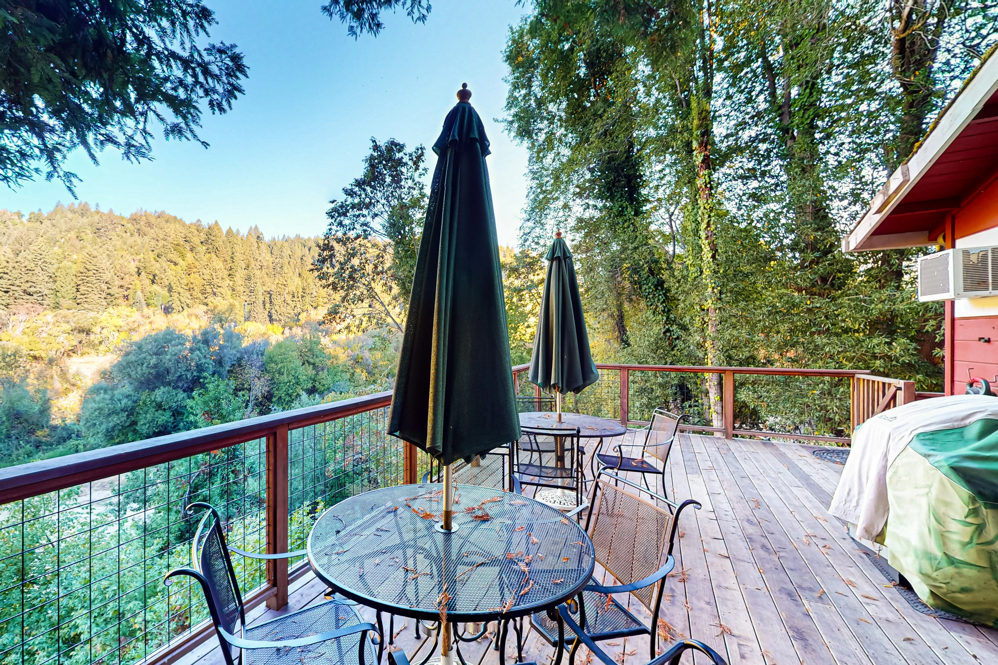 Sip your morning coffee at the elevated deck table while redwood-studded hillsides unfold before you — your private balcony above the Russian River canopy.