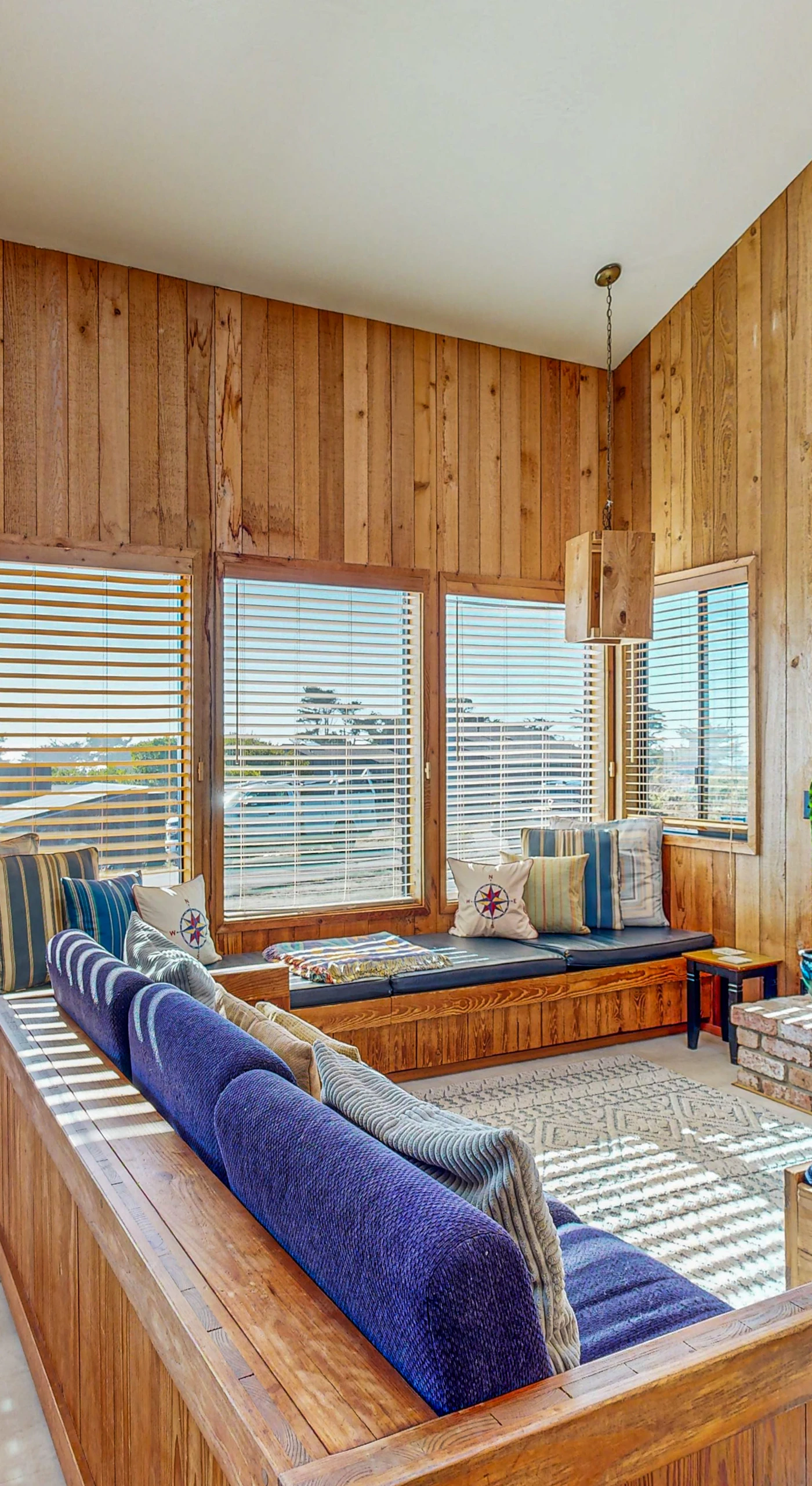 Imagine evenings spent in this cozy living room, where you can gather around the fireplace and enjoy the stunning ocean views through expansive windows.