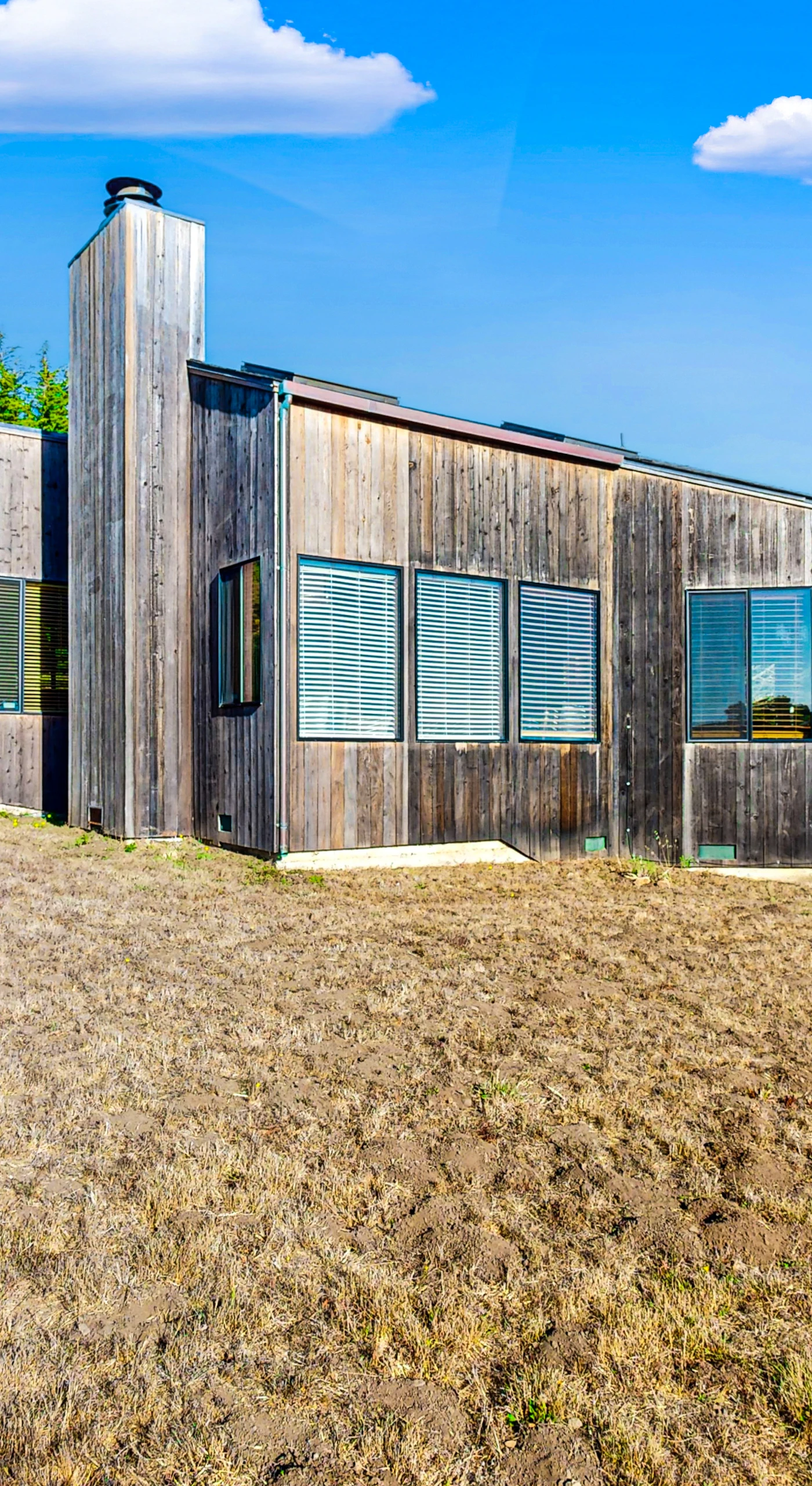 Experience the charm of Clemons' Cottage from the outside, featuring a unique design that blends seamlessly with the beautiful coastal landscape.