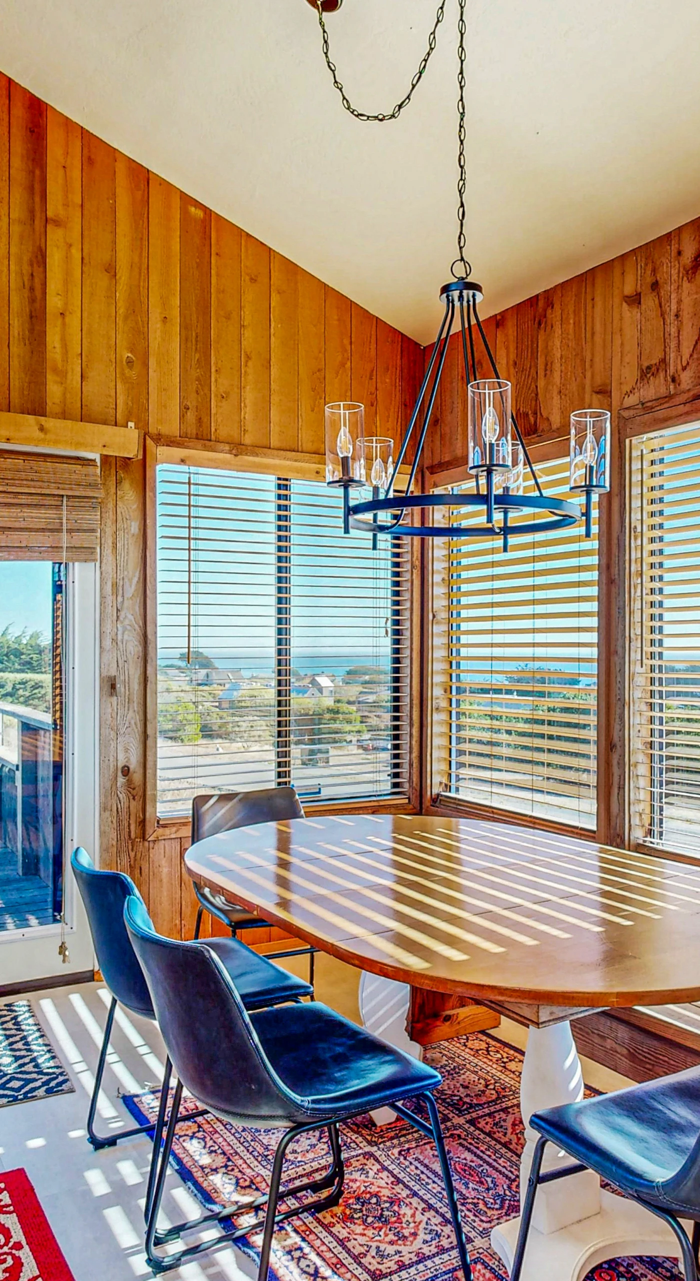 Dine with a view in this charming dining area, where large windows frame the ocean, creating a picturesque backdrop for your meals together.