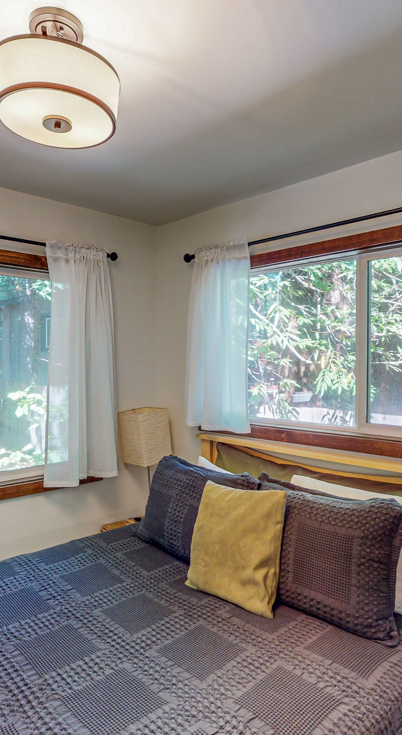 Drift off in your ground-floor queen bedroom wrapped in greenery views — two windows invite the quiet sounds of Cazadero nights.