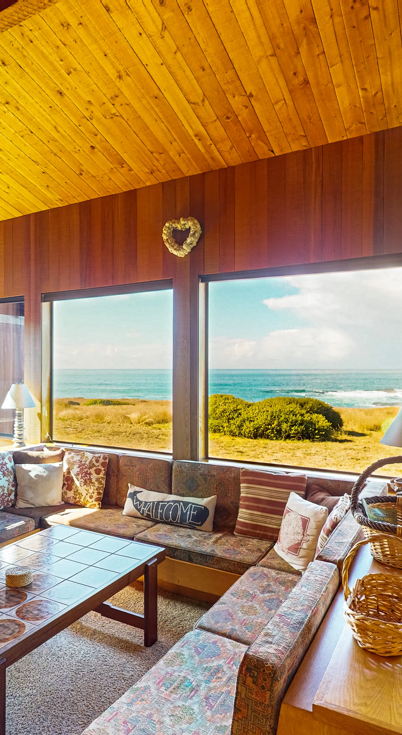 Morning light fills the living room, perfect for curling up with a book or enjoying a glass of wine while soaking in ocean views.