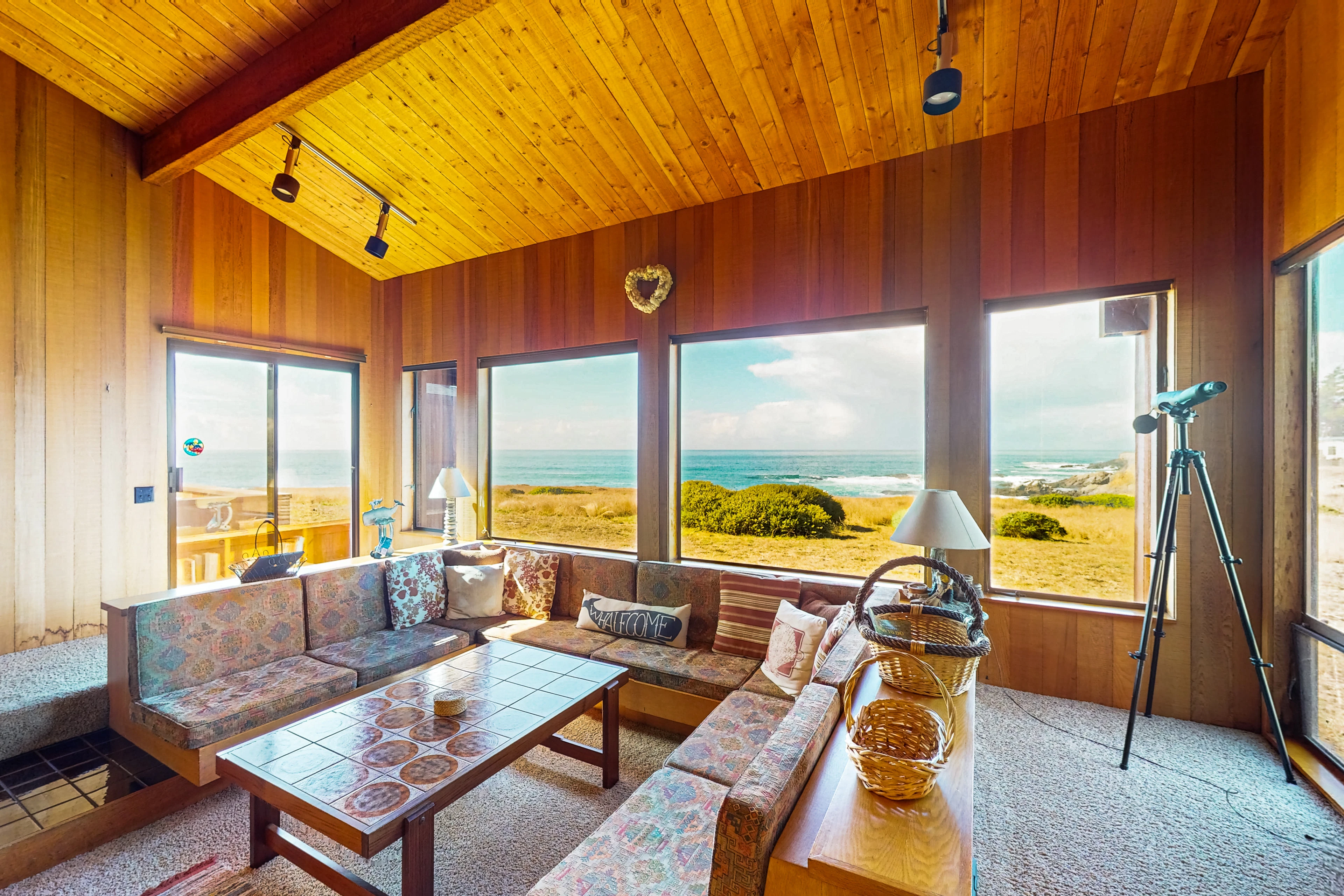 Morning light fills the living room, perfect for curling up with a book or enjoying a glass of wine while soaking in ocean views.