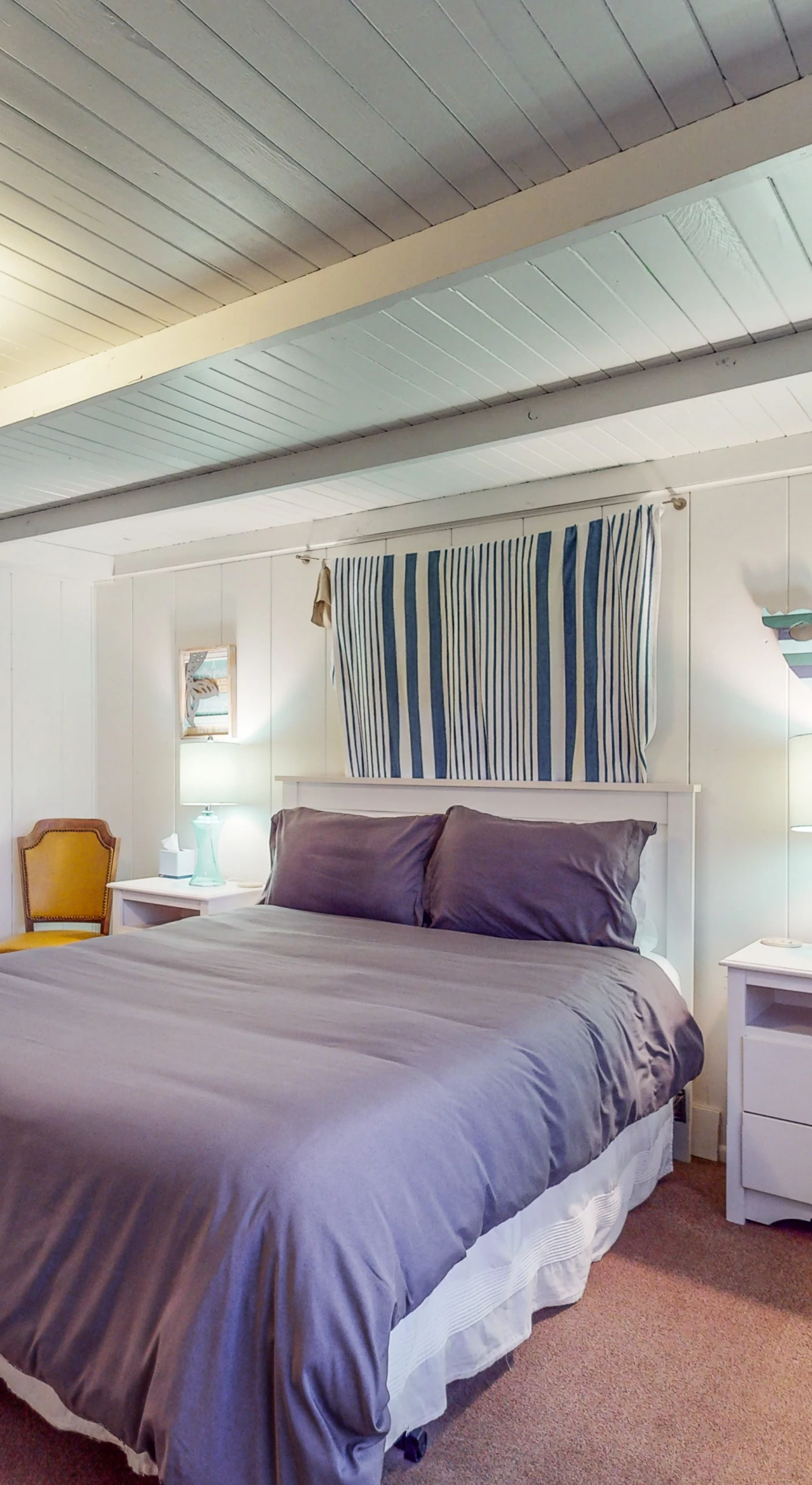 Drift off in your serene primary bedroom with a plush queen bed, vaulted beamed ceiling, and soft coastal tones — rest well after a day exploring Bodega Bay.