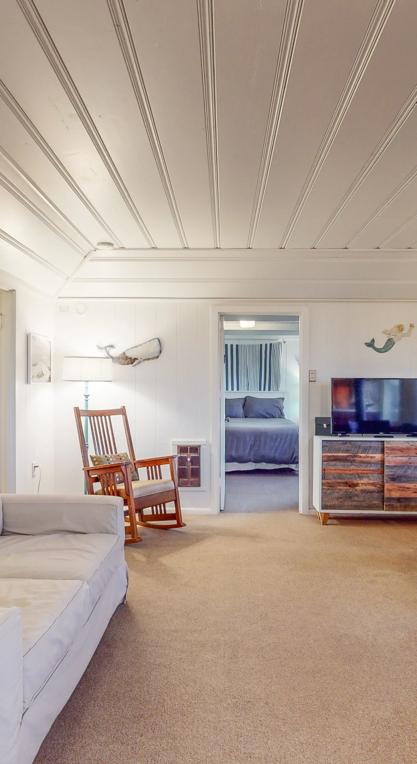 Settle into your sun-filled Bodega Bay living room with plush seating, coastal artwork, and a cozy banquette nook perfect for morning coffee overlooking the Sonoma Coast.