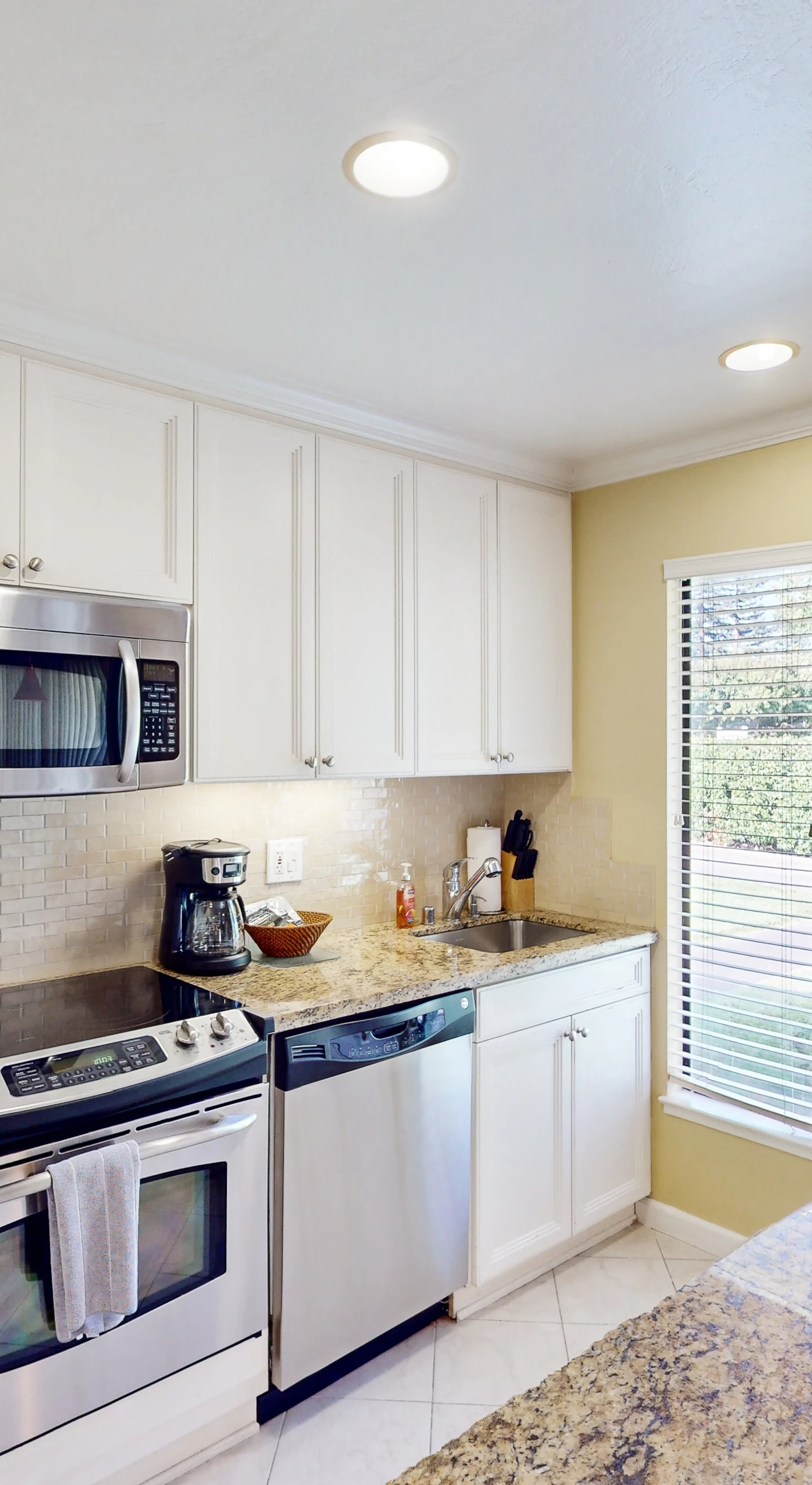 Prep your farm-to-table Napa Valley finds in a modern galley kitchen with granite countertops, stainless steel appliances, and crisp white cabinetry throughout.