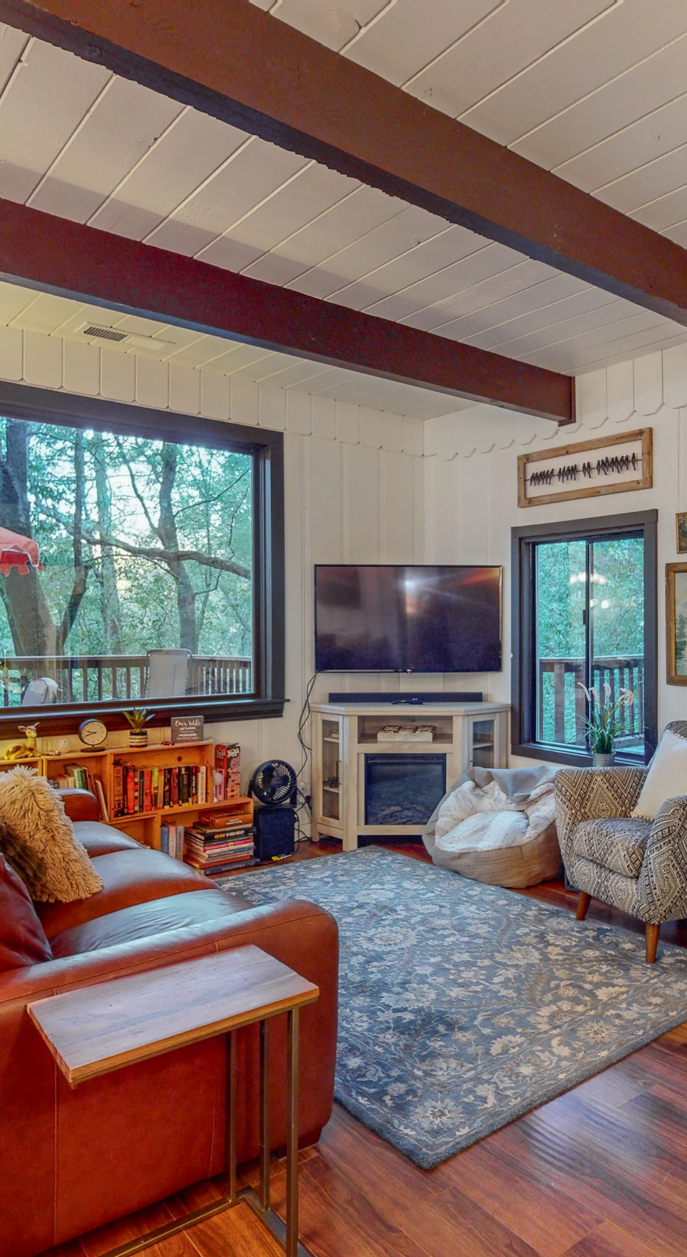 Sink into the leather sofa after a day of Forestville wine tasting — exposed timber beams, hardwood floors, and forest views through oversized windows make your living room a true retreat.