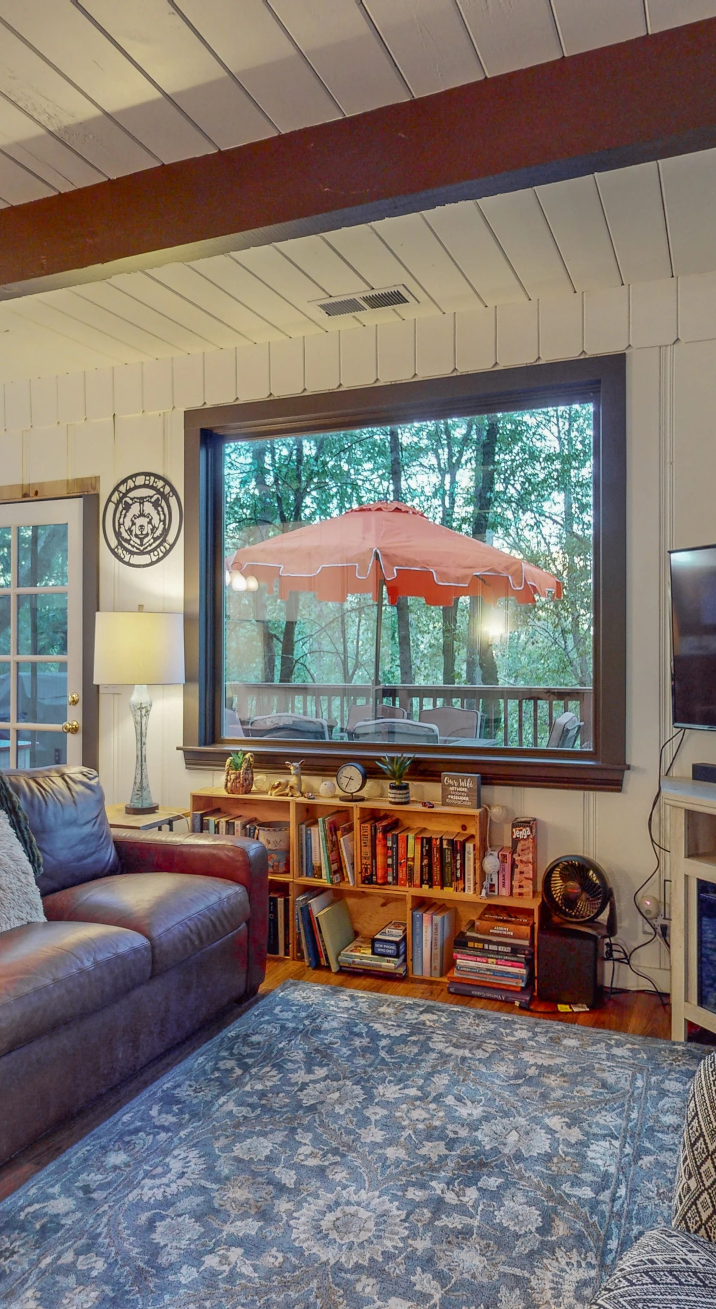 Catch a movie on your flat-screen TV while the treetops sway beyond the windows — this open-plan living space connects seamlessly to your fully equipped kitchen.