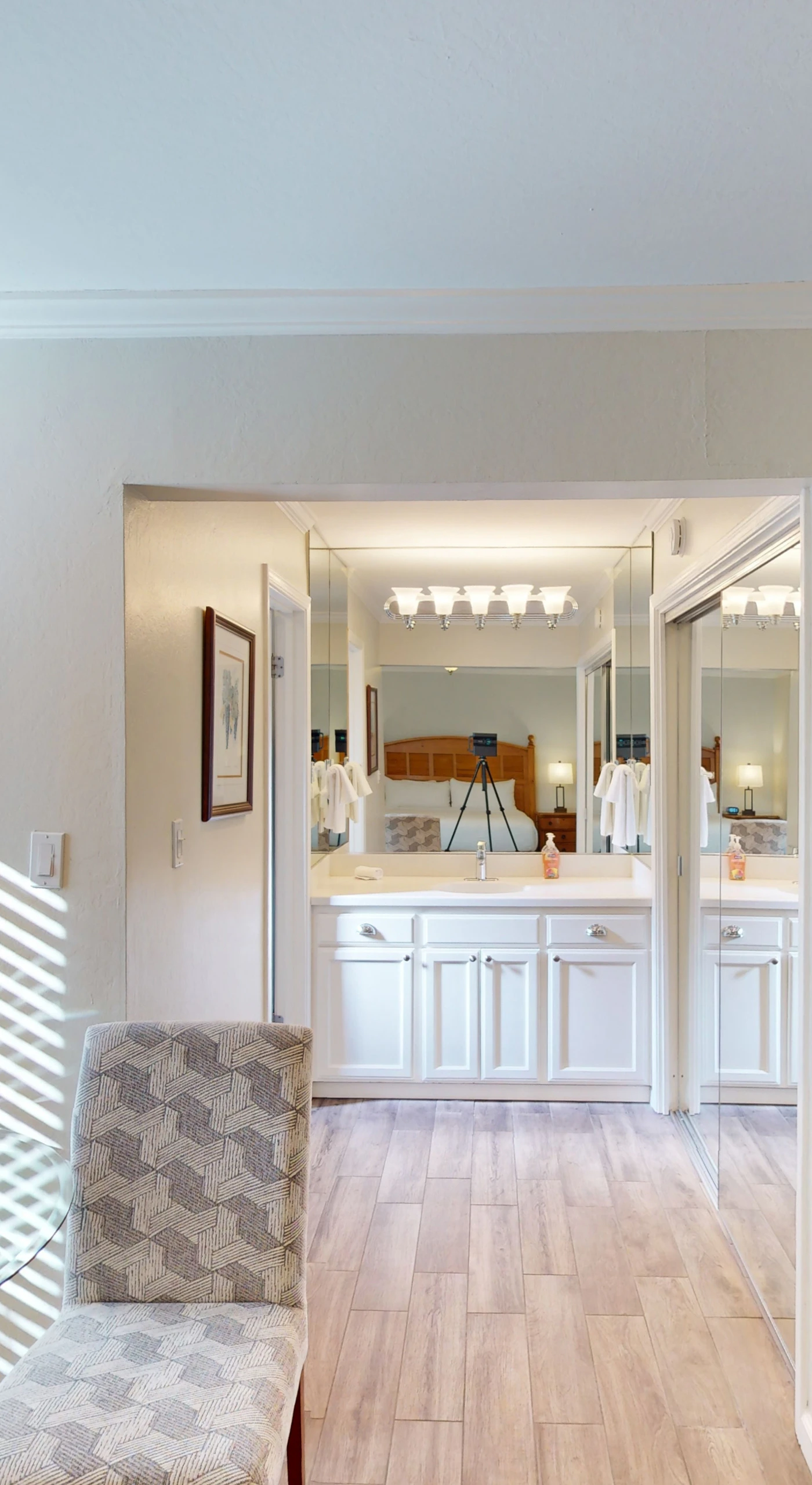 Plan your next Napa Valley winery visit from a bright, airy sitting area with modern furnishings and an entertainment center steps from the bathroom.