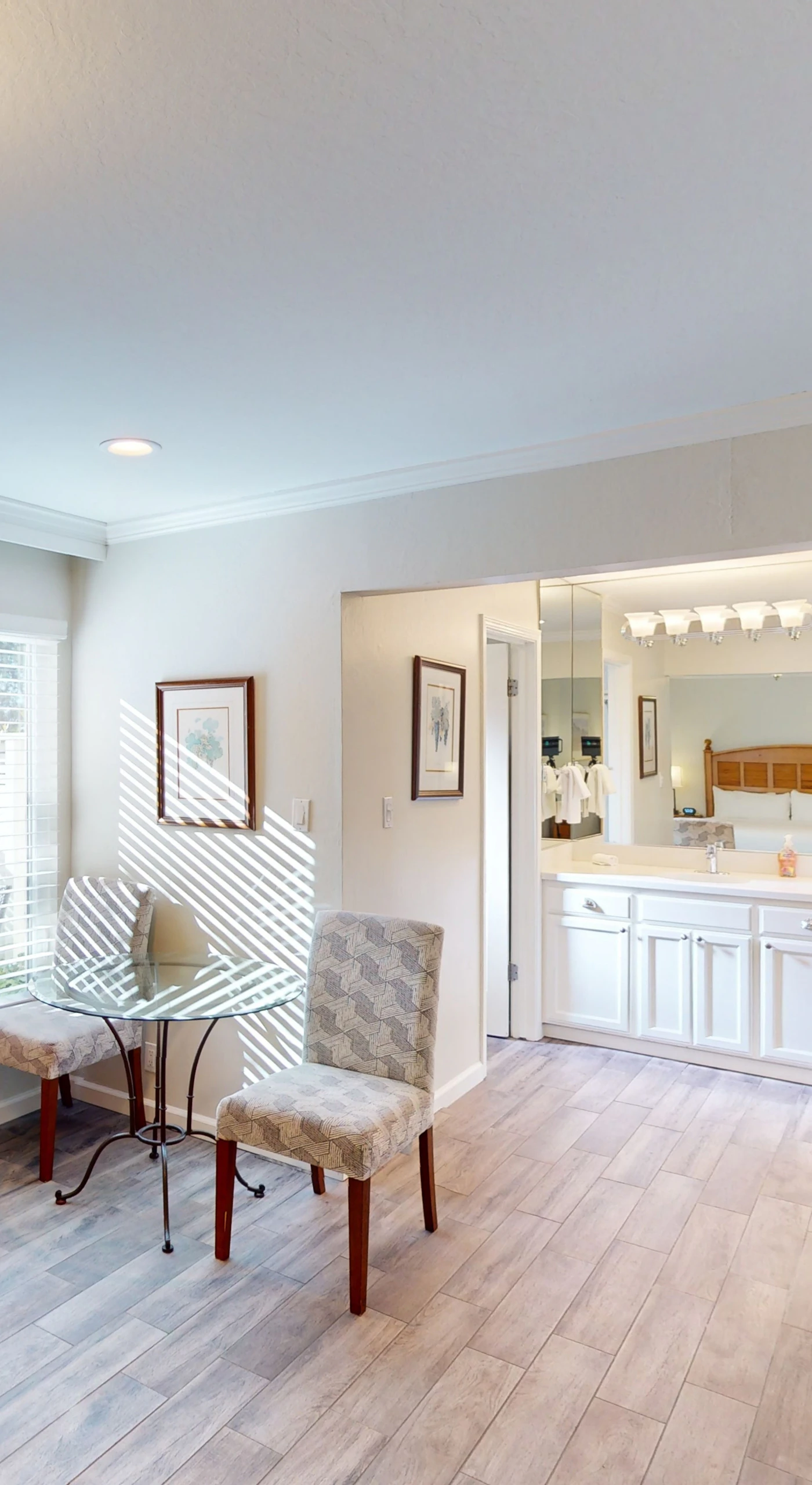 Unwind in your open-plan living space with stylish striped armchairs and a wall-mounted TV — your Napa Valley home base between vineyard adventures.