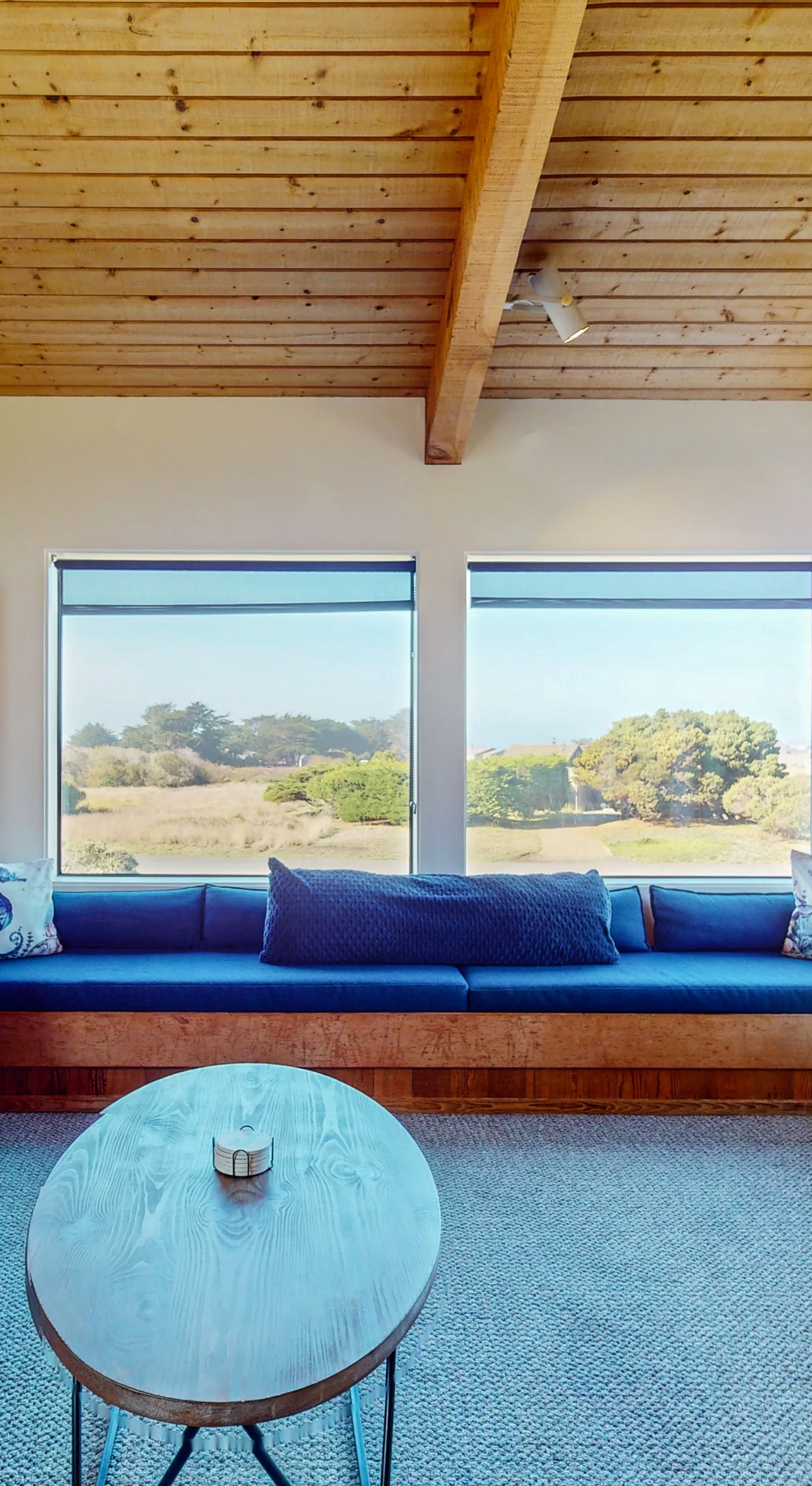 Morning light fills this living space, offering the perfect spot for leisurely afternoons spent watching the waves from the comfort of your couch.