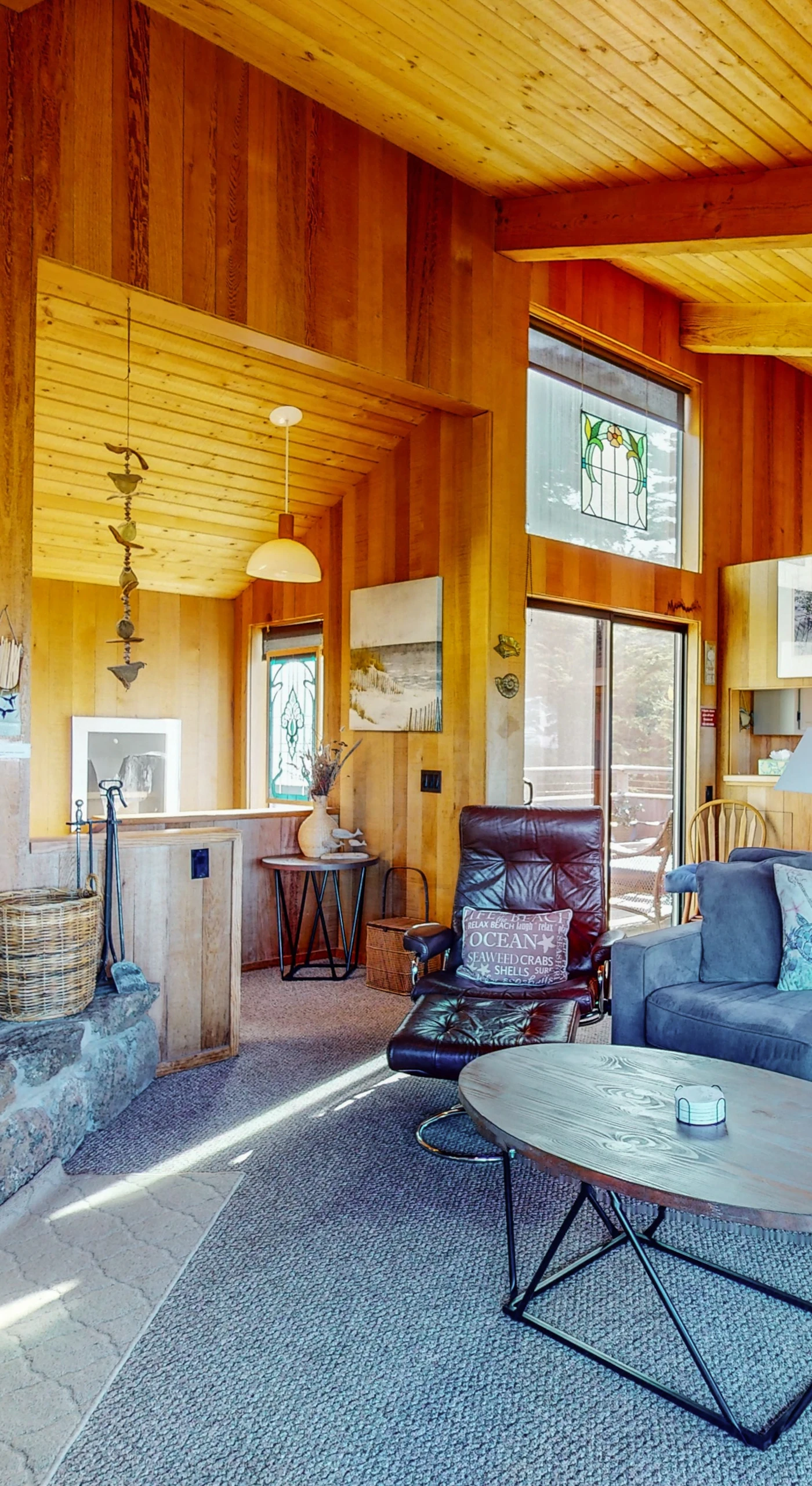 Gather around the inviting living room, where the warmth of the stone fireplace enhances your evenings spent with loved ones.