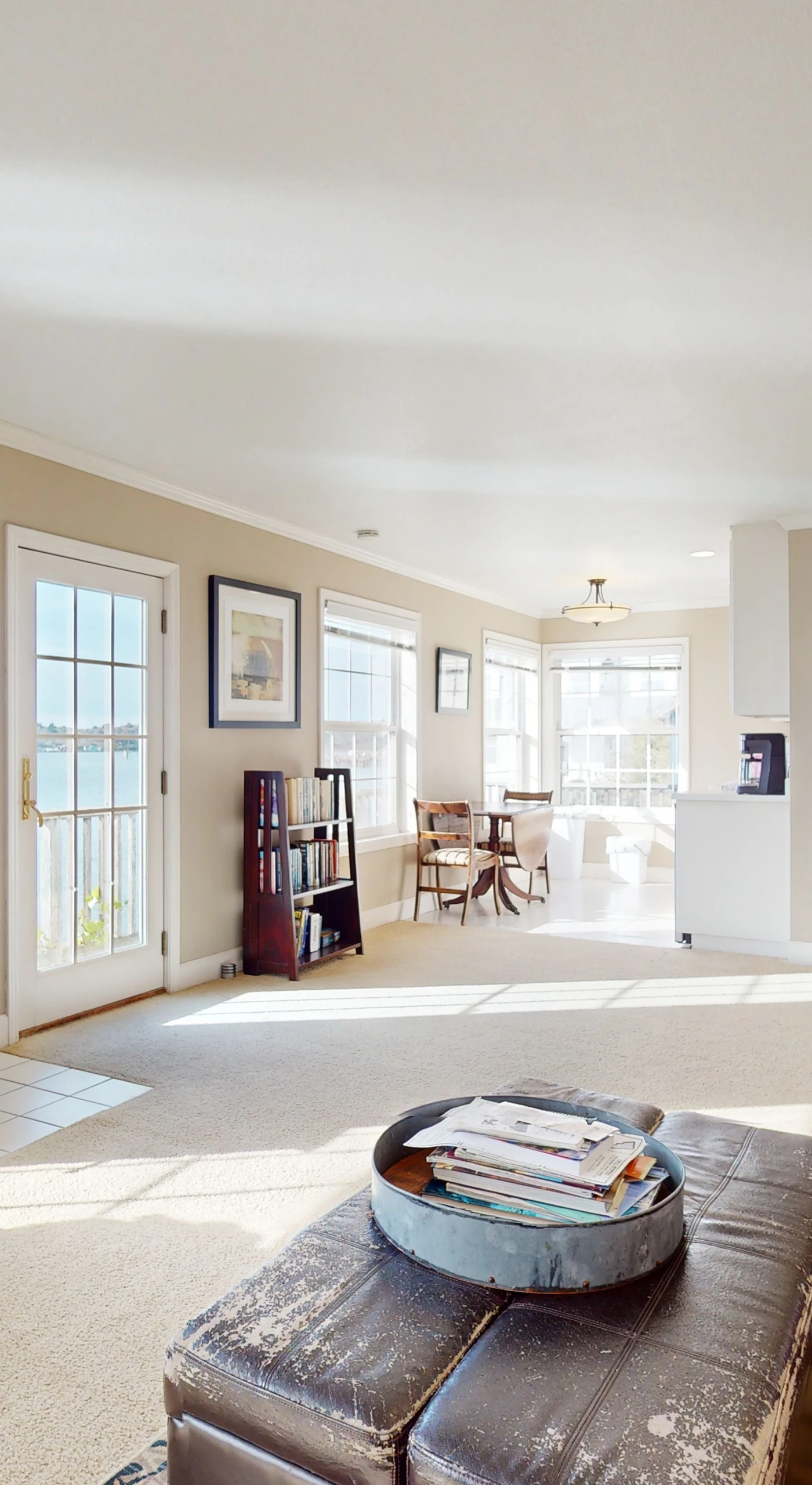 French doors flood the living space with natural light and open directly onto the bay, blurring the line between indoors and out.