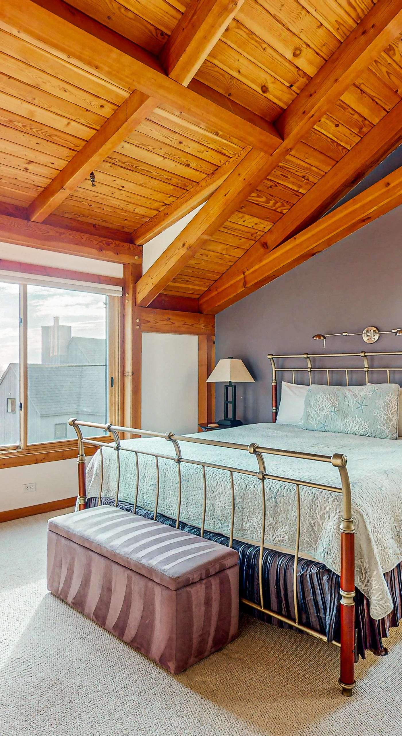 Awake in the master bedroom, where the large windows frame lovely views, inviting morning light and a peaceful start to your day.