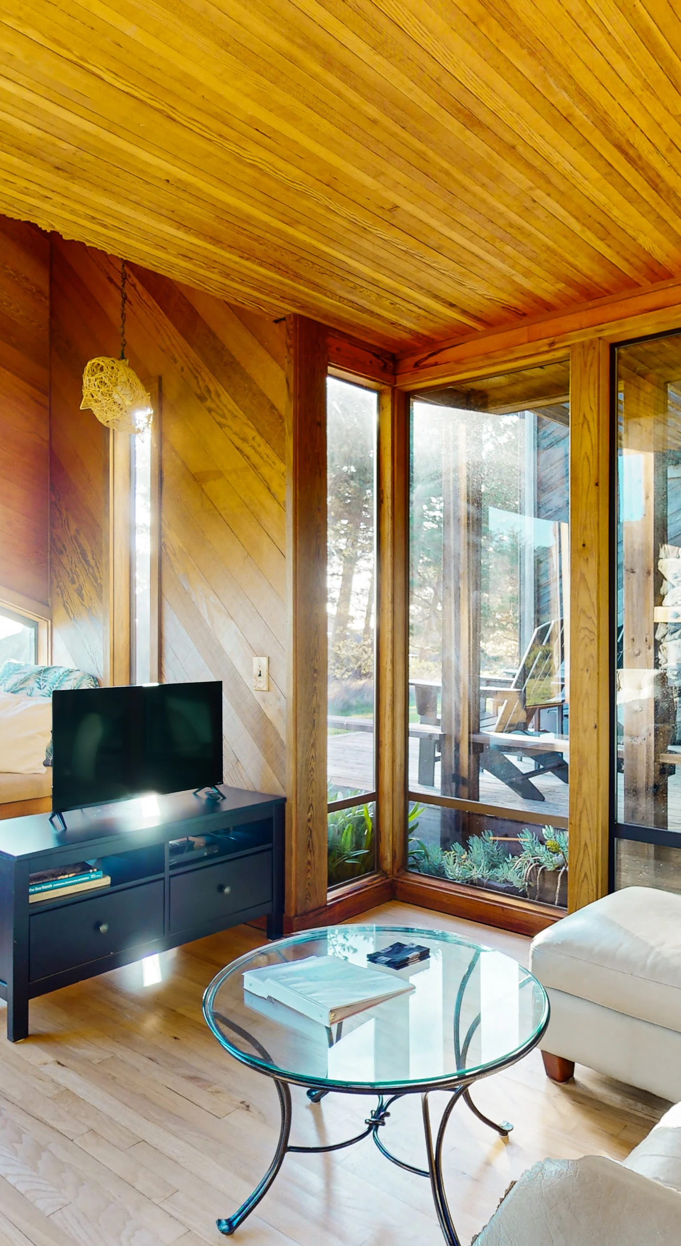 Natural light floods the living room, creating a warm and inviting atmosphere perfect for cozy evenings by the wood-burning fireplace.