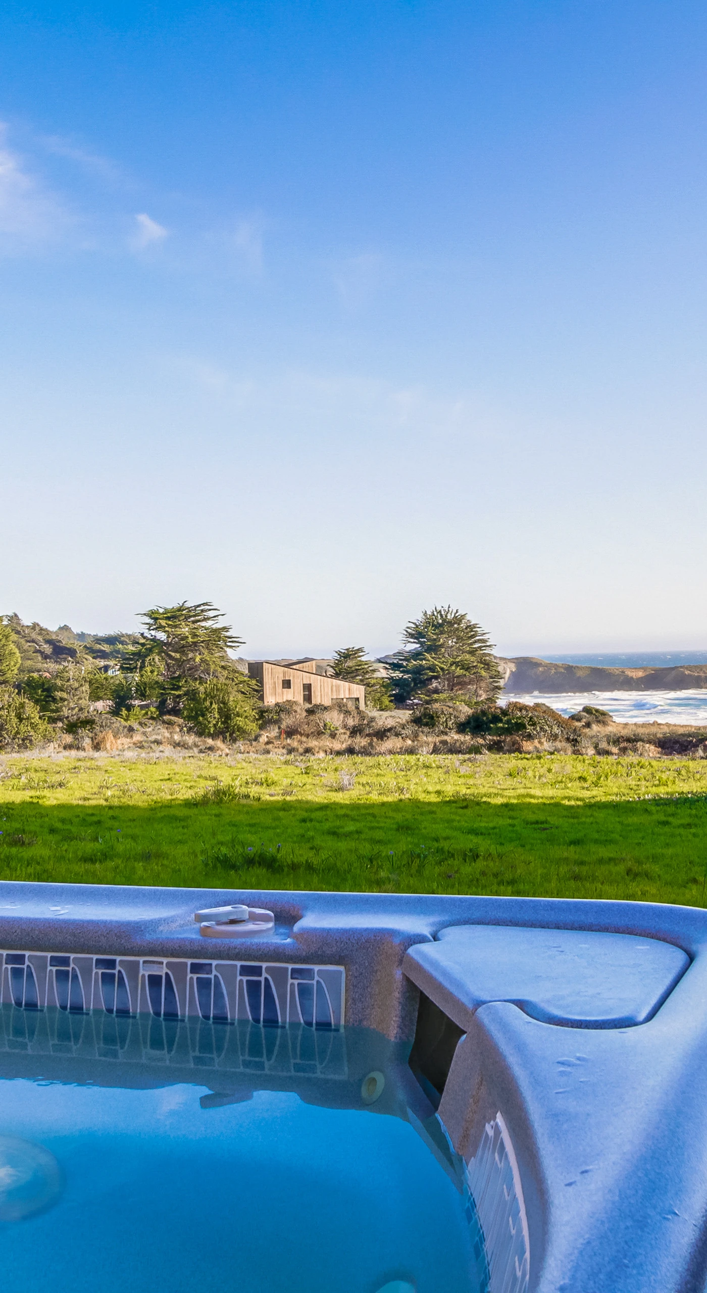 Soak under the stars in your private hot tub, where the ocean breeze and stunning views create the perfect evening ambiance.