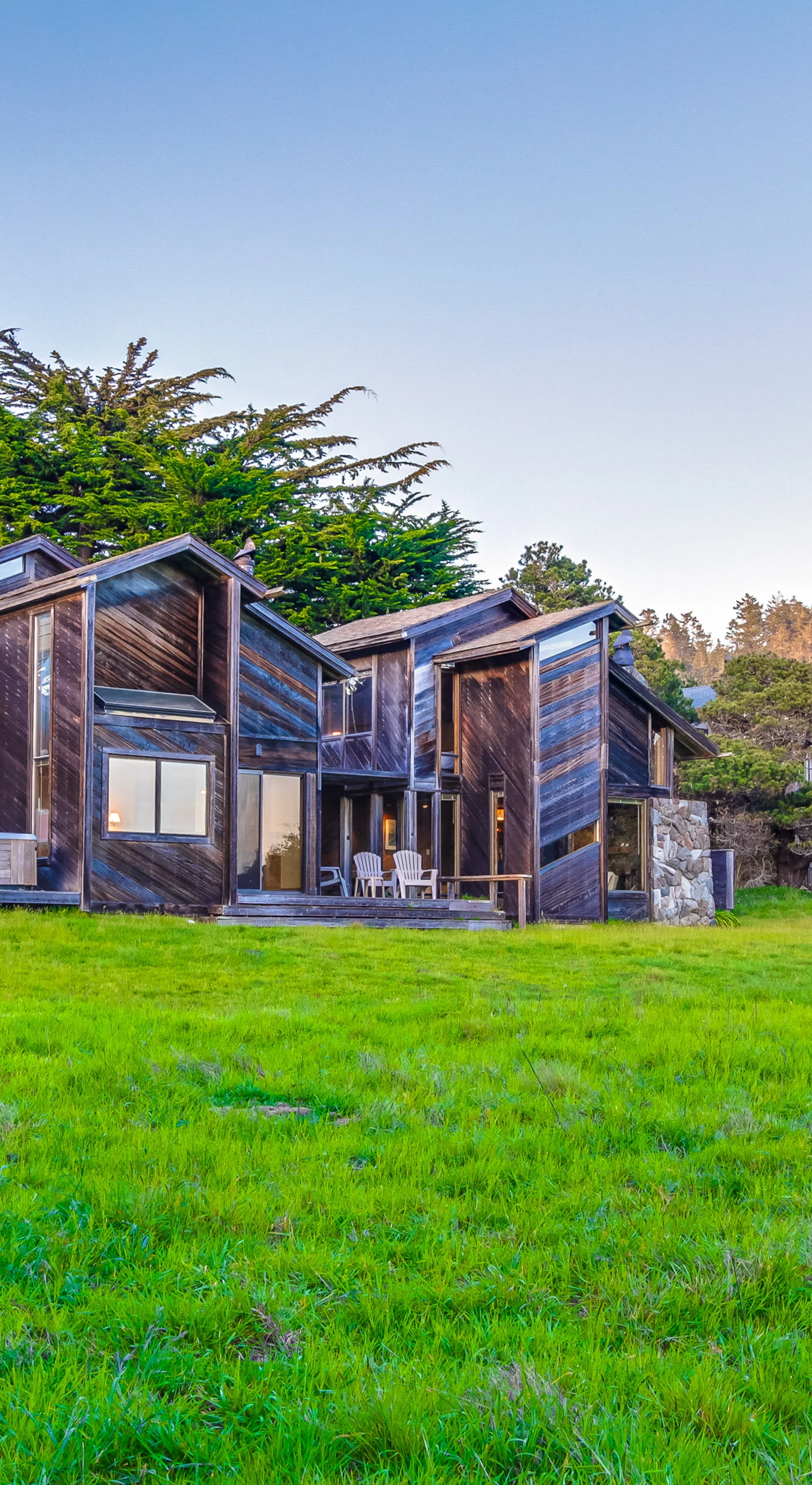 Admire the unique architecture of your coastal retreat, harmoniously blending with the lush surroundings for a truly immersive Sea Ranch experience.