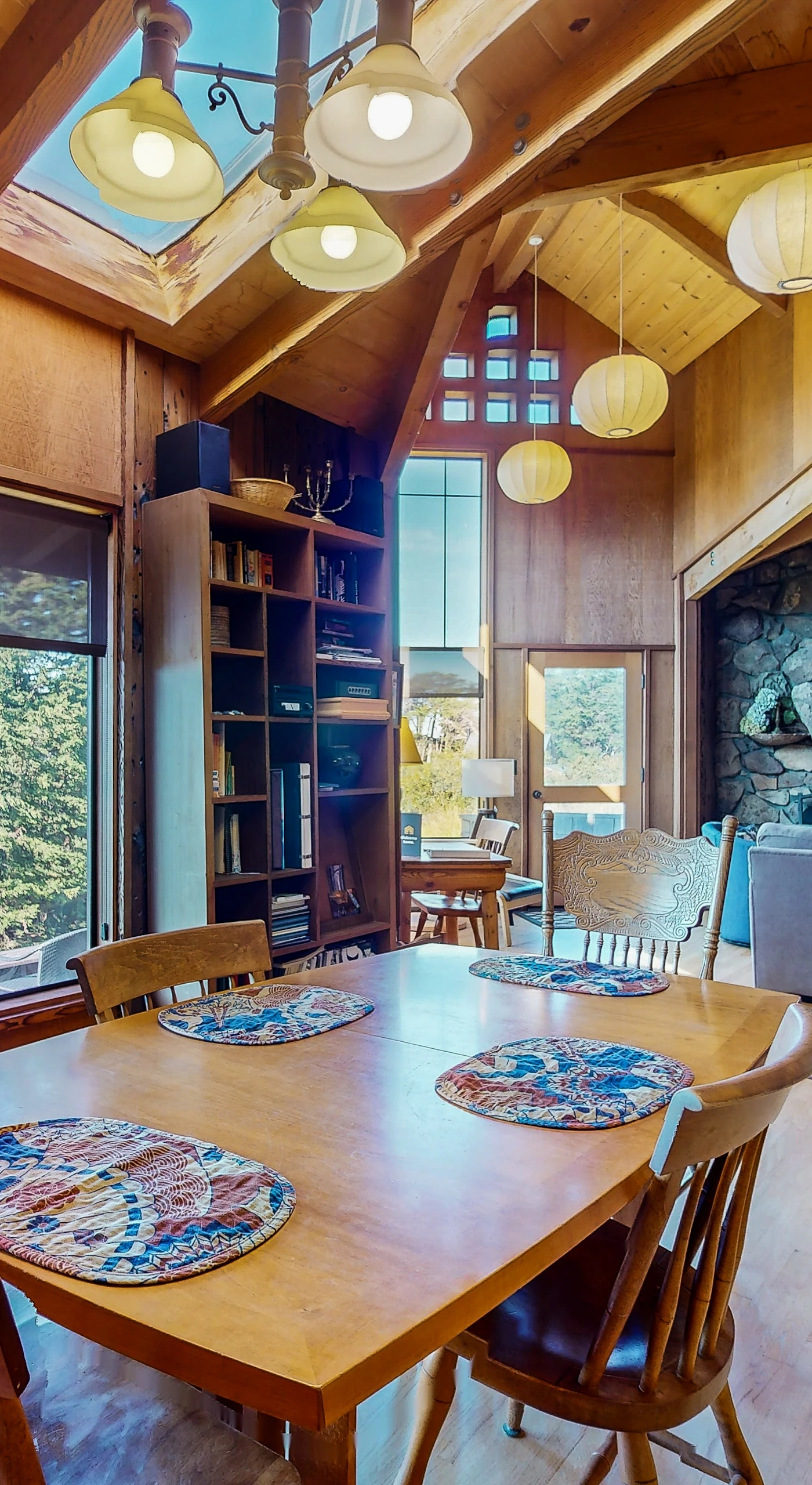 Dine in style as you watch the sunset through expansive windows, making every meal a memorable experience in this inviting space.