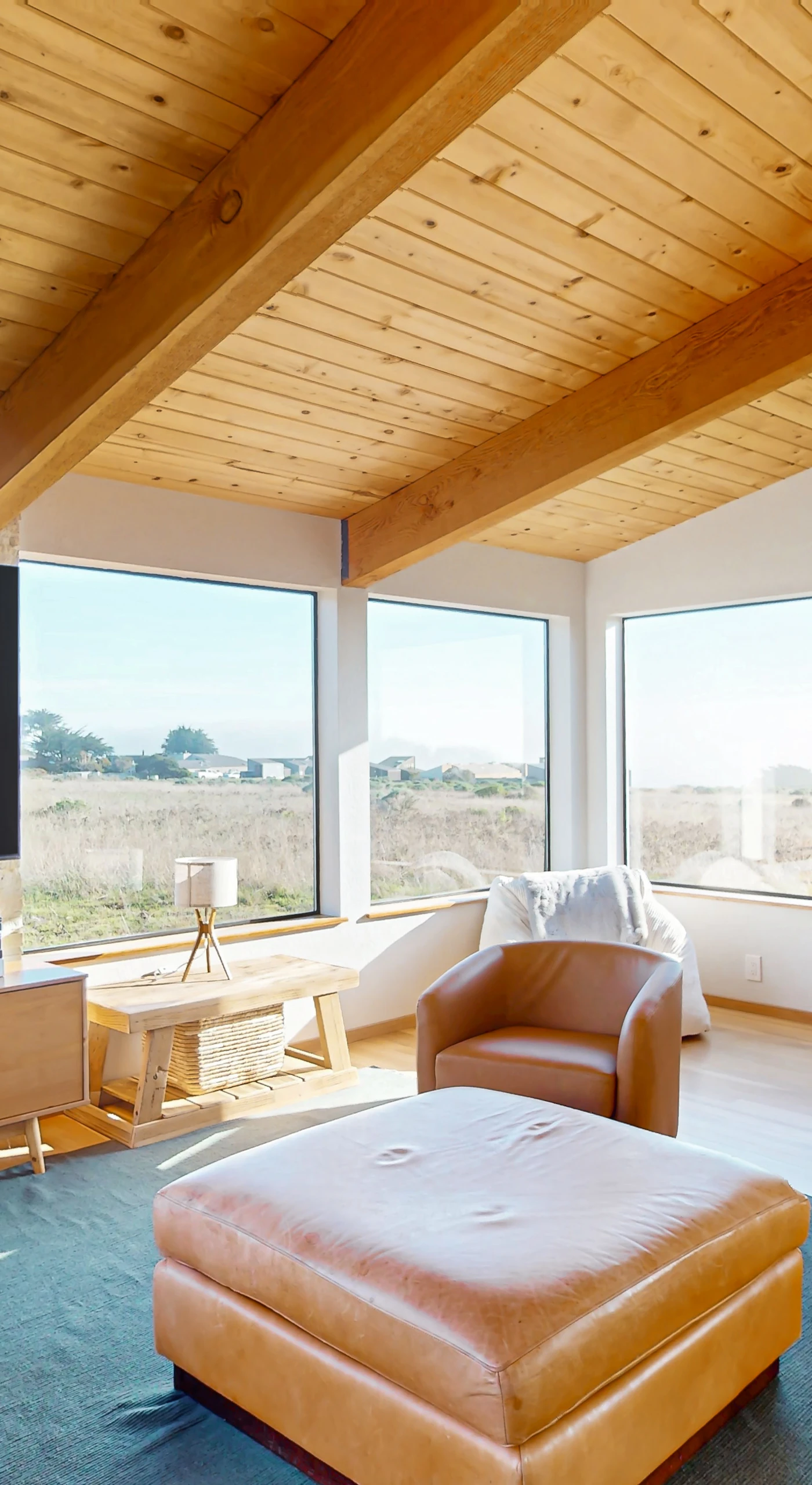 Picture yourself lounging in this sun-soaked living room, where comfort meets coastal charm and the ocean beckons just outside.