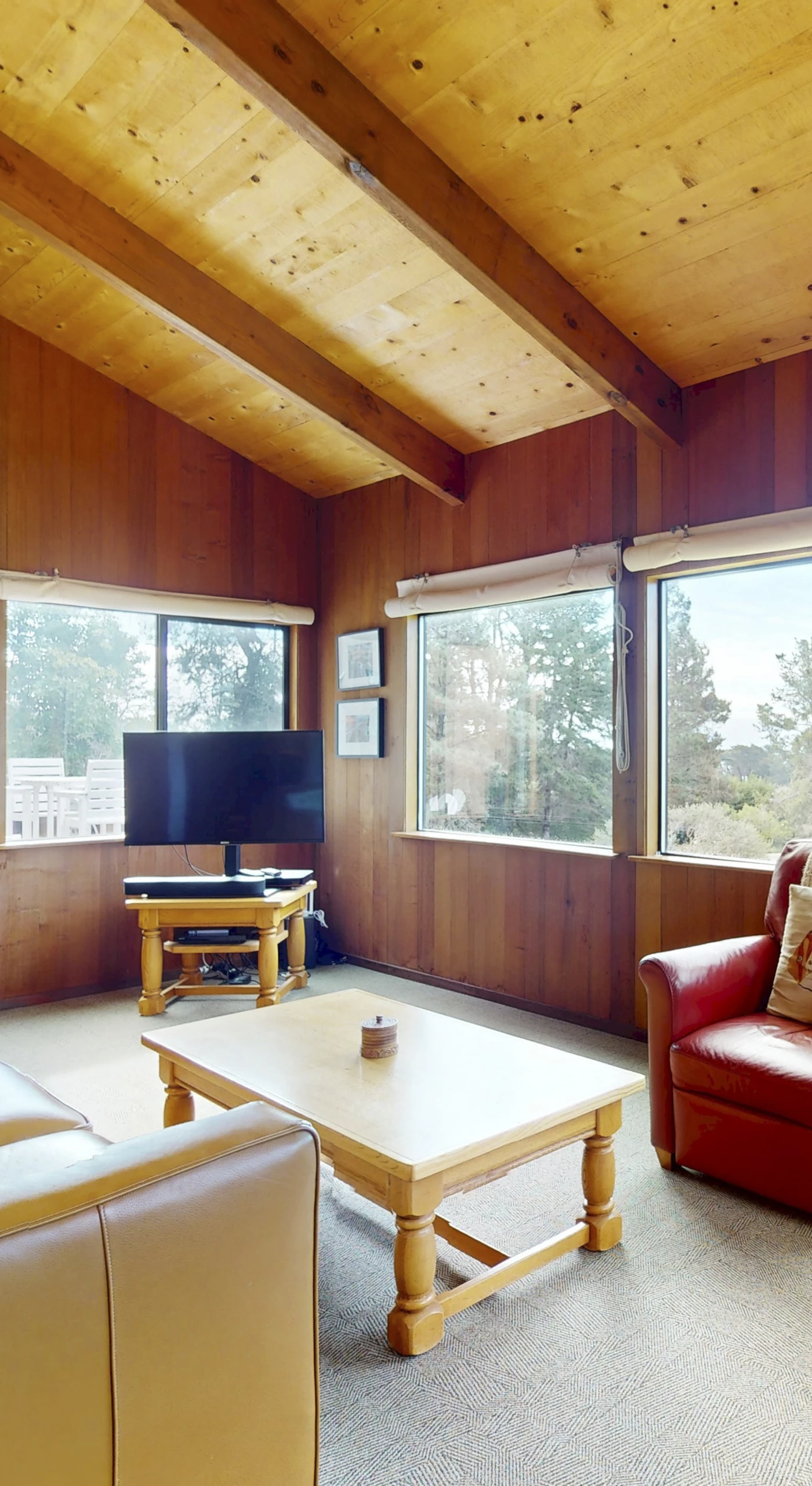 Morning light floods this cozy living space, inviting you to relax and enjoy ocean views from every angle.